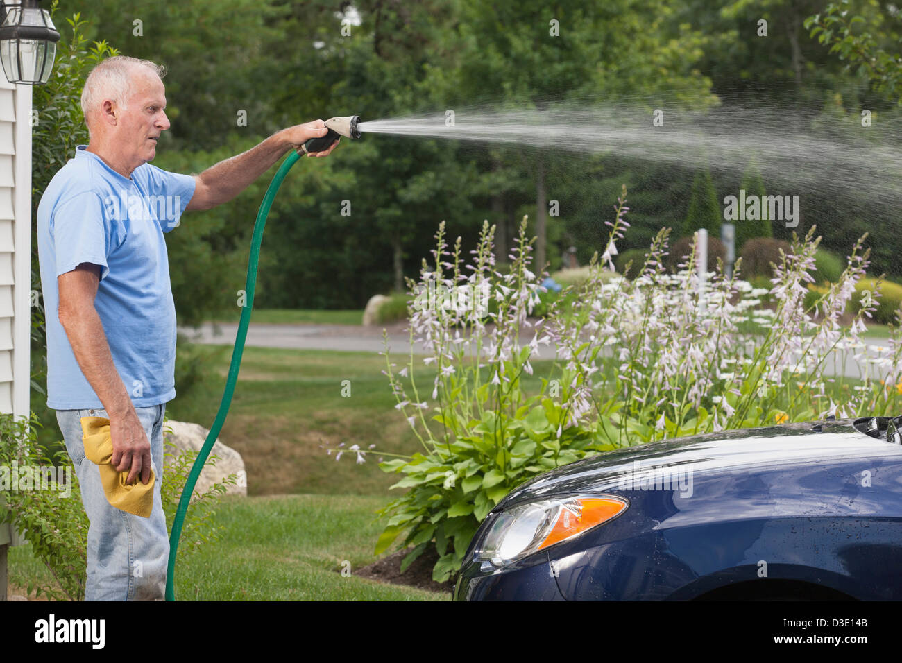 Senior man washing his car at home Stock Photo Alamy