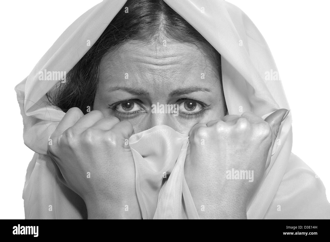 scared girl in white hijab isolated on white background, monochrome image Stock Photo
