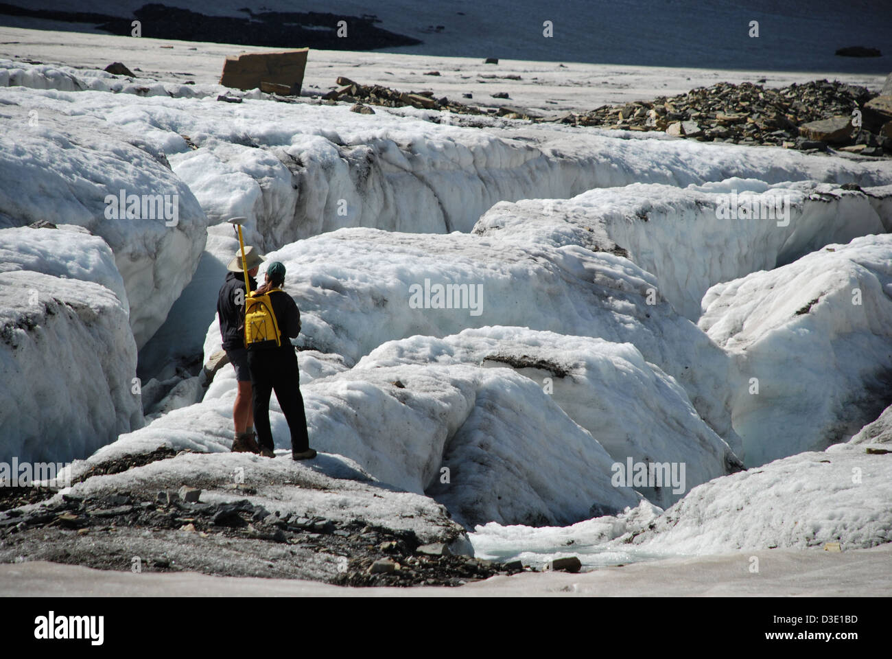 Scientists measuring the terminus of Grinnell Glacier Stock Photo