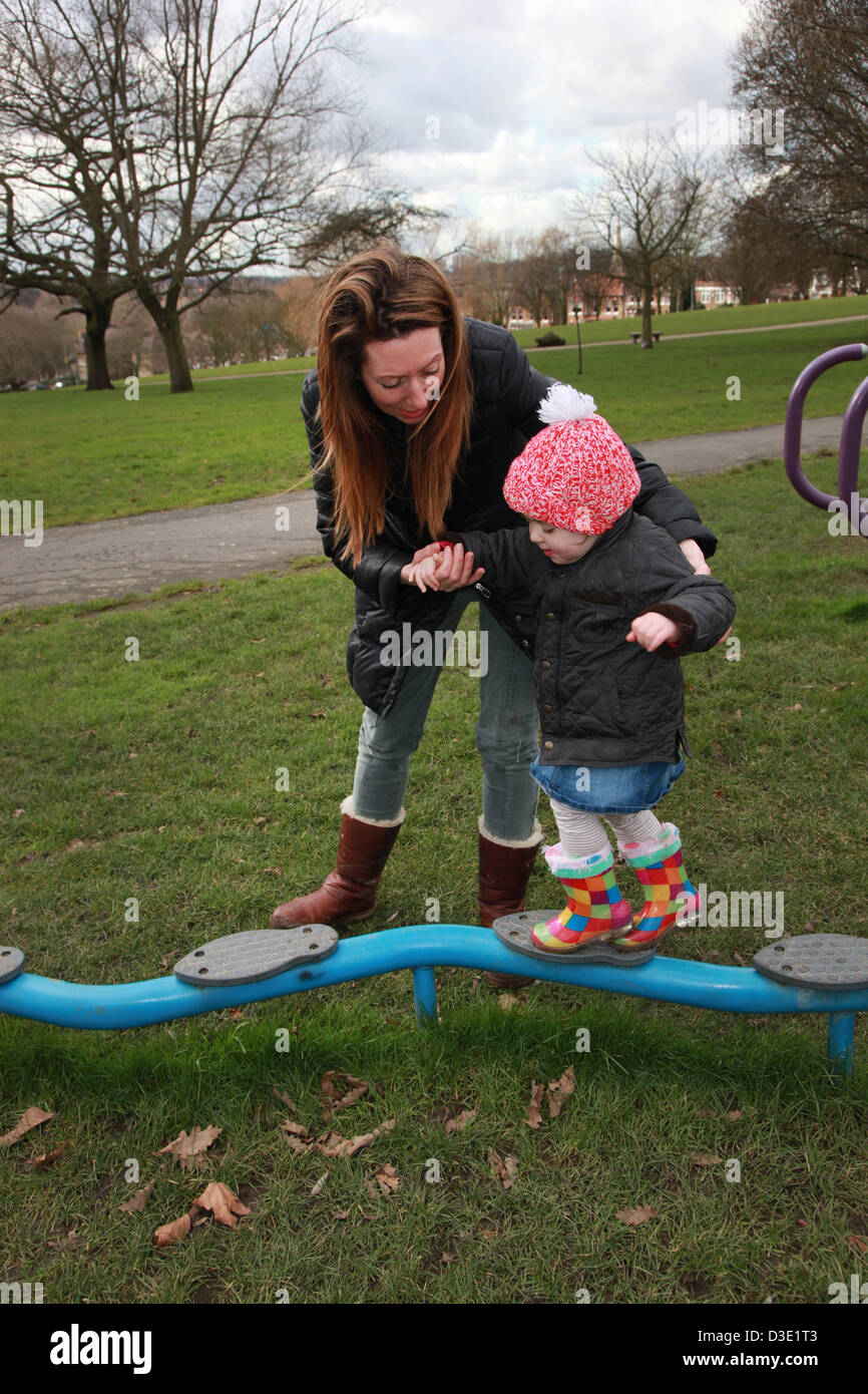Mum and toddler playing in the park in the winter, UK Stock Photo