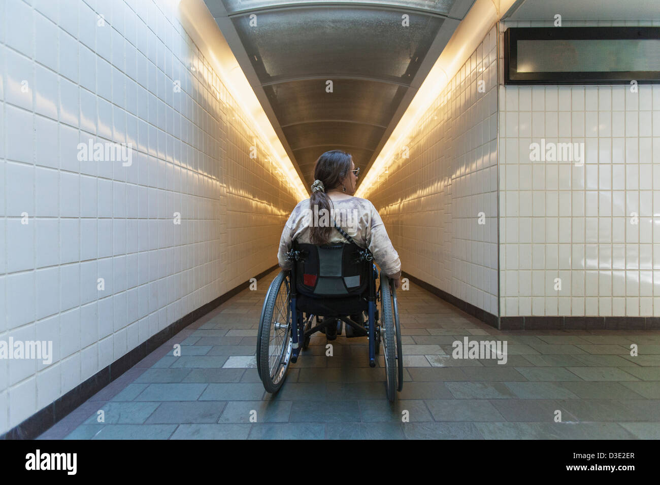 Woman with spinal cord injury in a wheelchair accessing subway train station, Boston, Massachusetts, USA Stock Photo