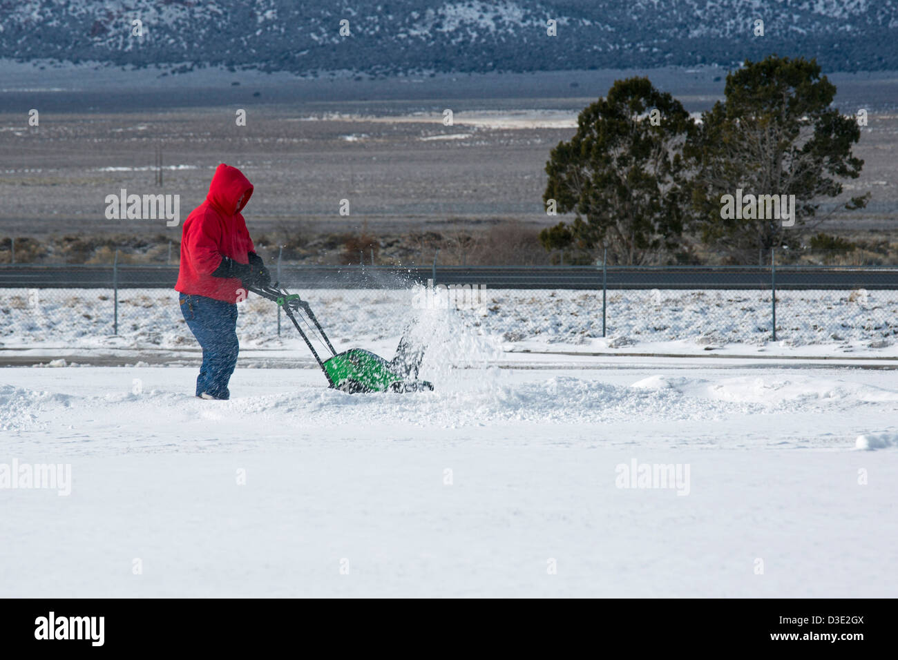 Paragonah, Utah - A worker clear snow at a rest area on Interstate 15 in Southwestern Utah. Stock Photo