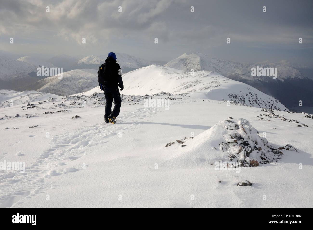 Winter mountain walking in Scotland. Male walker on the summit of Sgorr nam Fiannaidh in Glencoe Stock Photo