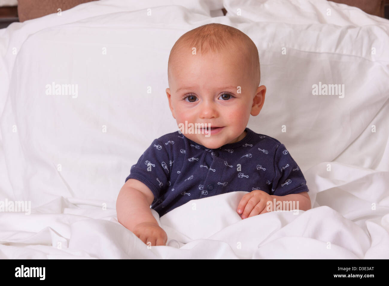 Baby sitting on bed hi-res stock photography and images - Alamy