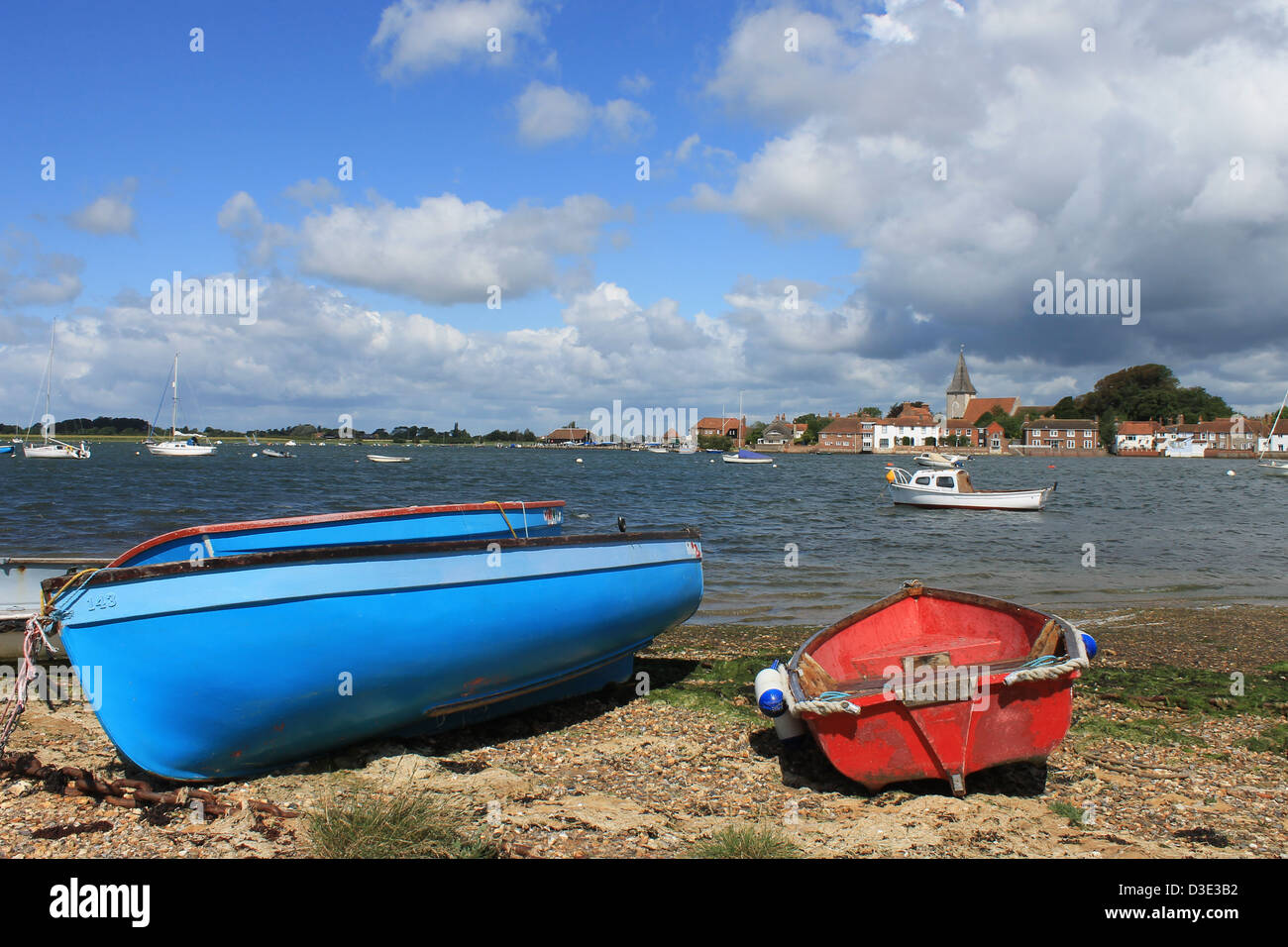 Chichester Harbour view towards Bosham, West Sussex, UK, with small boats on the foreshore Stock Photo