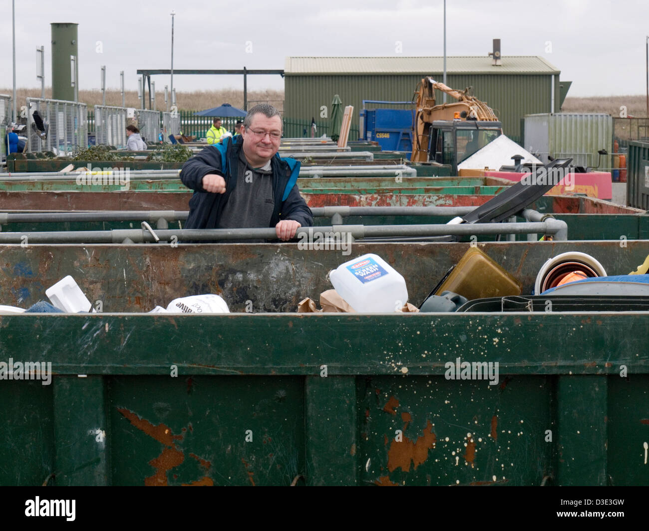 man throwing unwanted items into a skip at a recycling center Stock ...