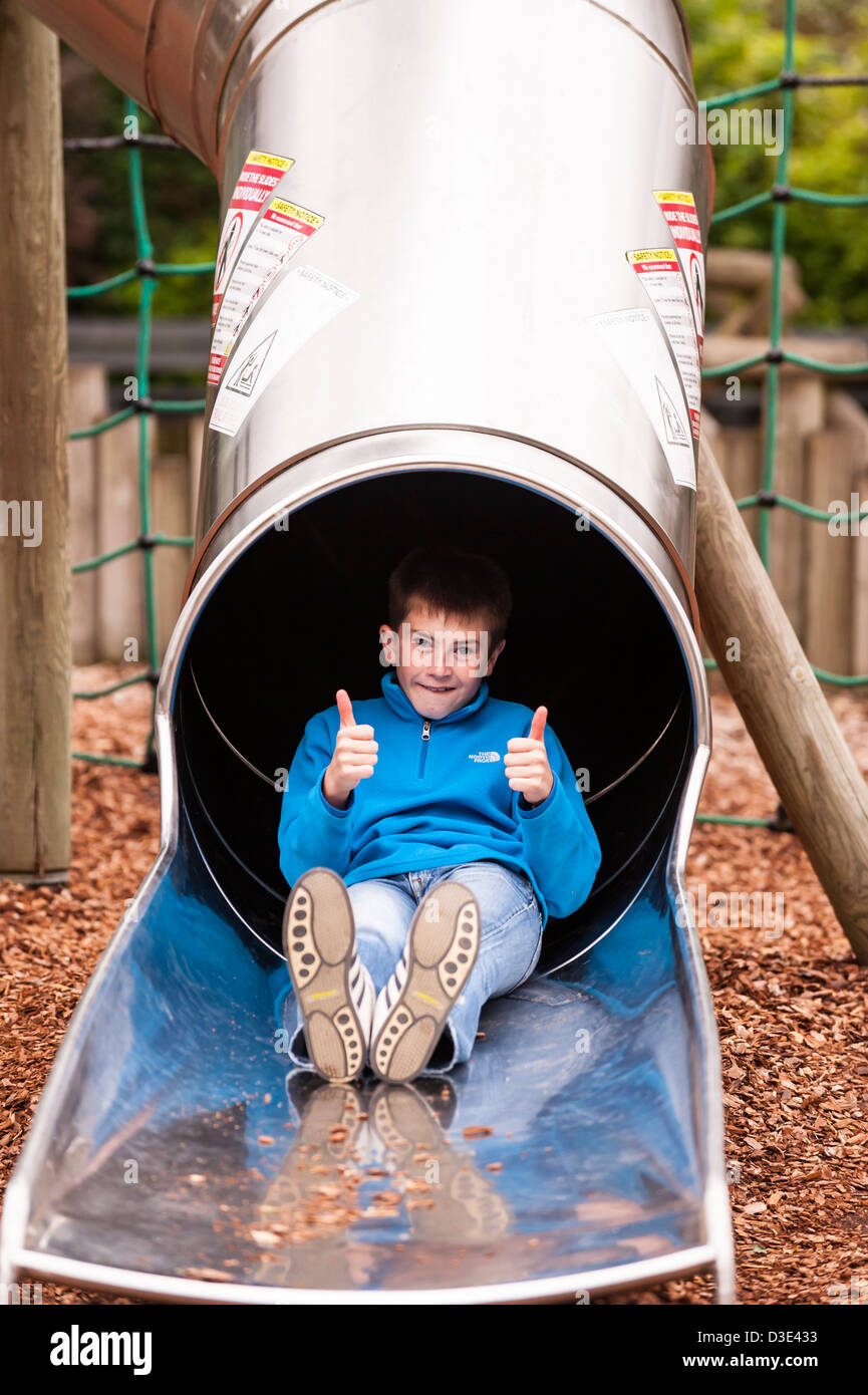 A boy plays on the slide at Banham Zoo , Norfolk , England , Britain , Uk Stock Photo