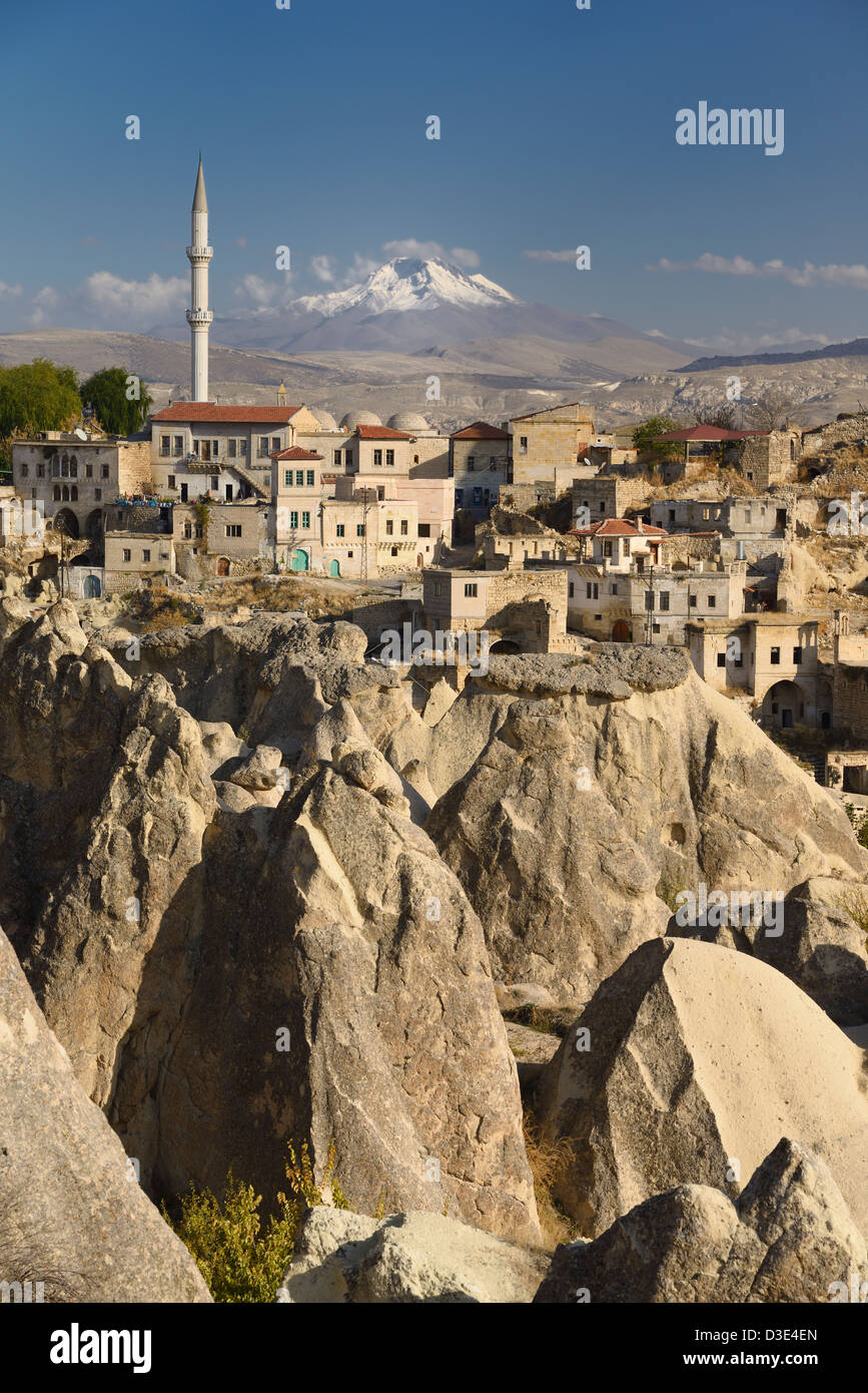 Houses and Mosque in Ortasihar village with view of Mount Erciyes and fairy chimney hoodoos Cappadocia Turkey Stock Photo