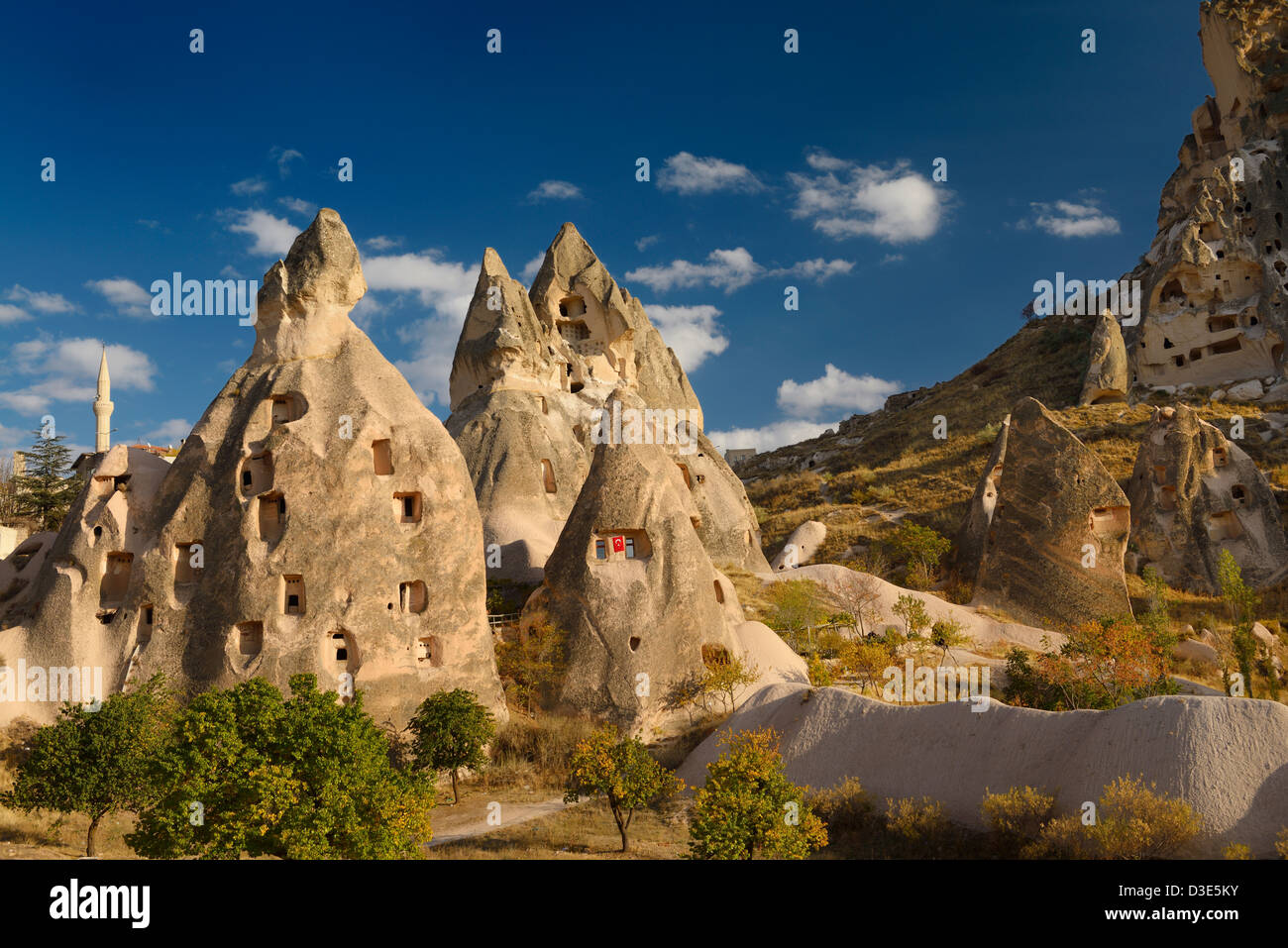 Ancient cave houses carved in volcanic tuff at Uchisar at sunset