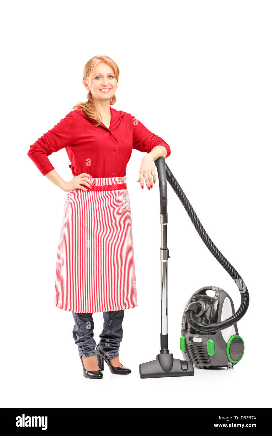 Full length portrait of a blond housewife posing on a vacuum cleaner isolated on white background Stock Photo
