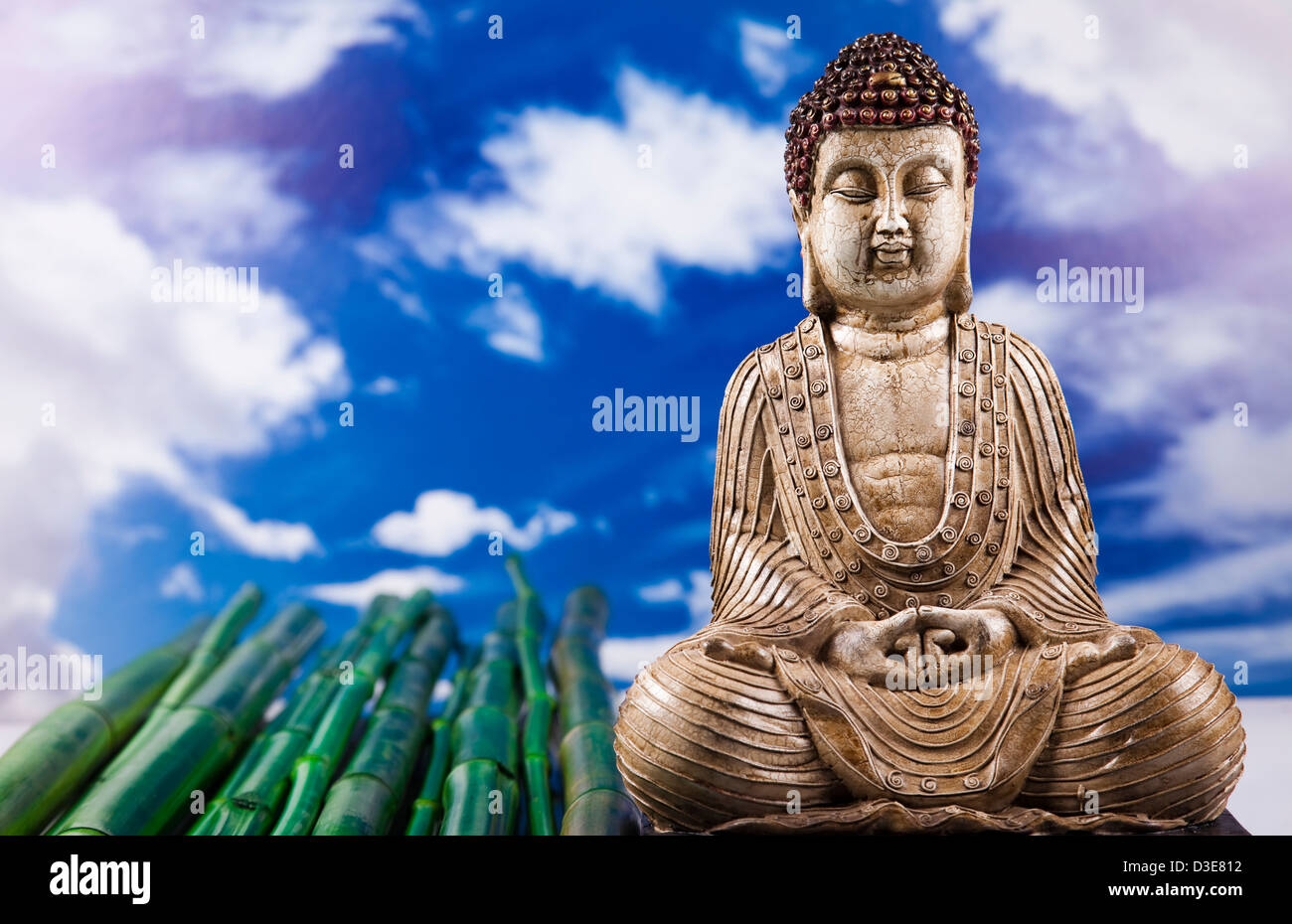 Buddha statue and bamboo on blue sky background Stock Photo - Alamy