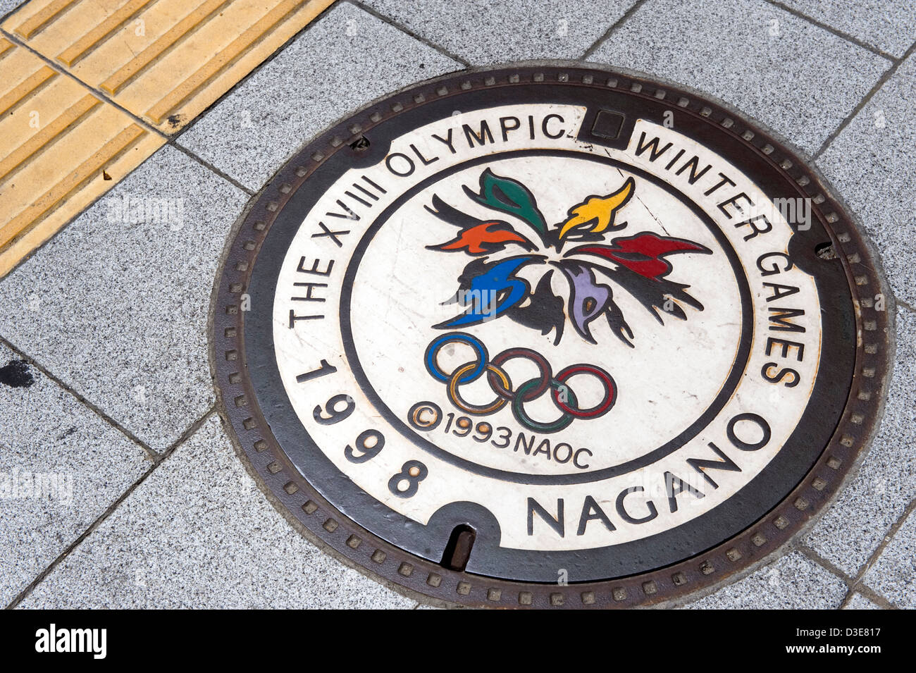 An artistic manhole cover celebrating the 18th Winter Olympic Games of 1998 in Nagano City, Japan. Stock Photo