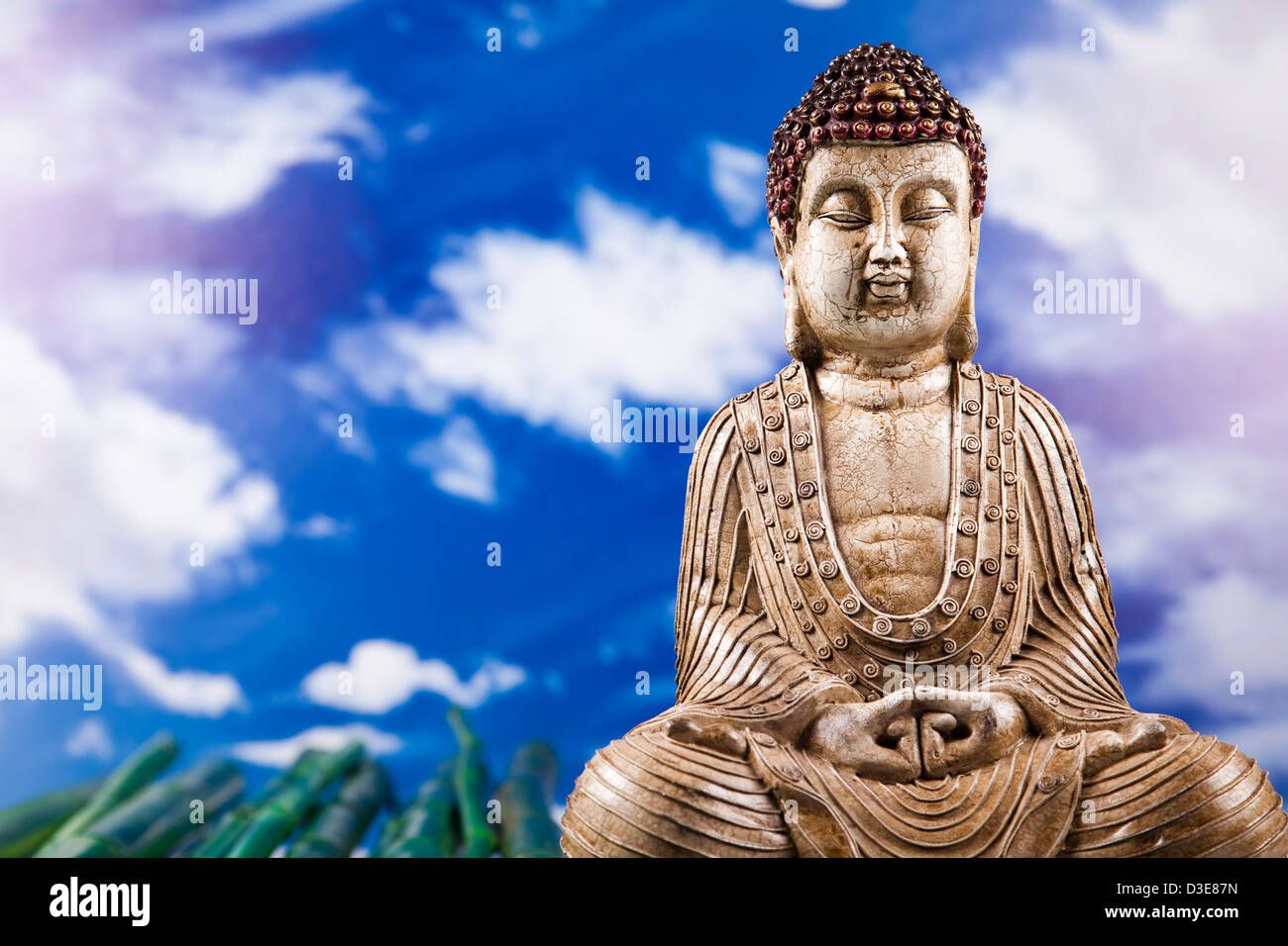 Buddha statue and bamboo on blue sky background Stock Photo - Alamy
