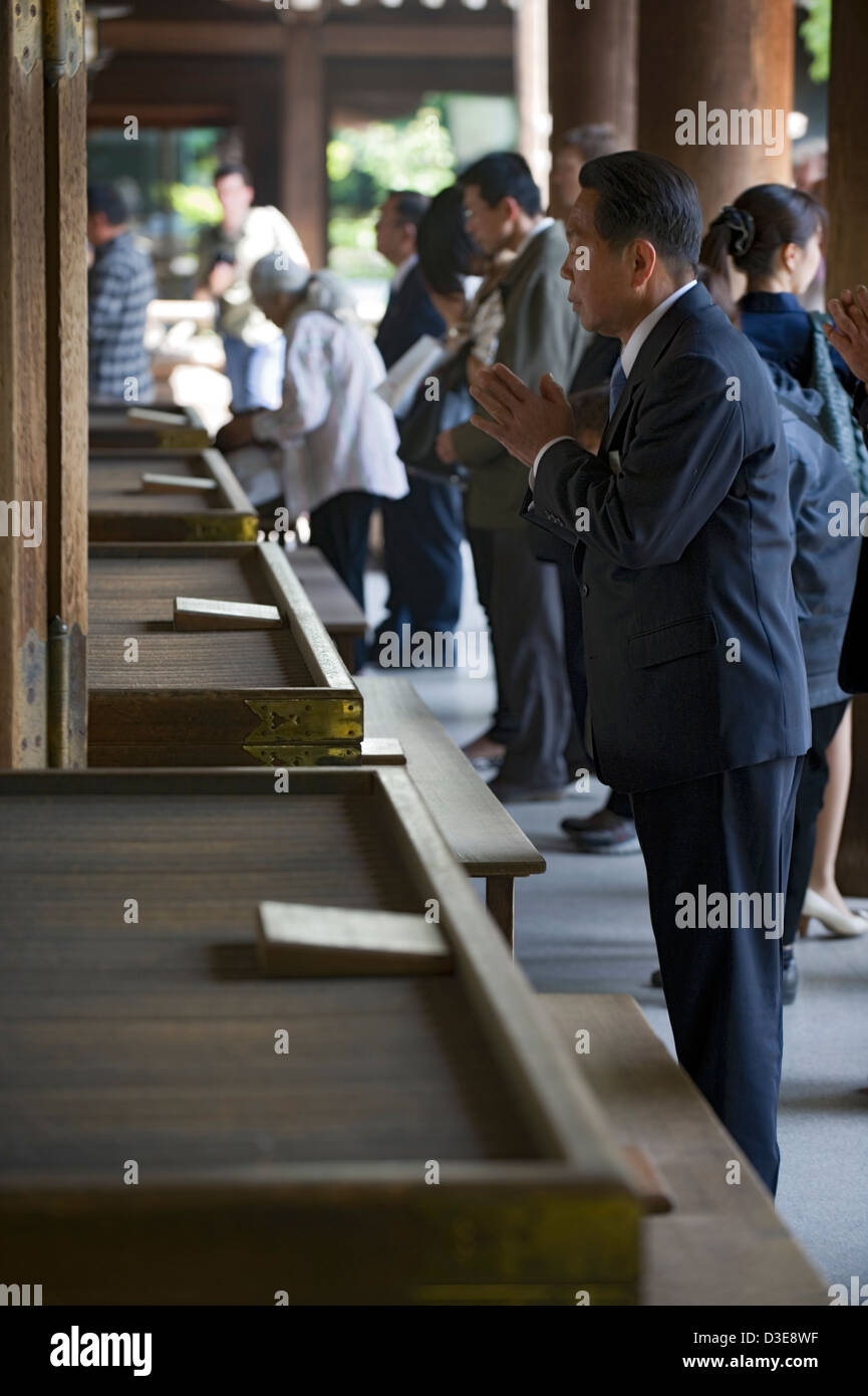 Worshipers make a wish and pray to the Imperial deity enshrined at the Meiji Jingu shrine in Tokyo. Stock Photo