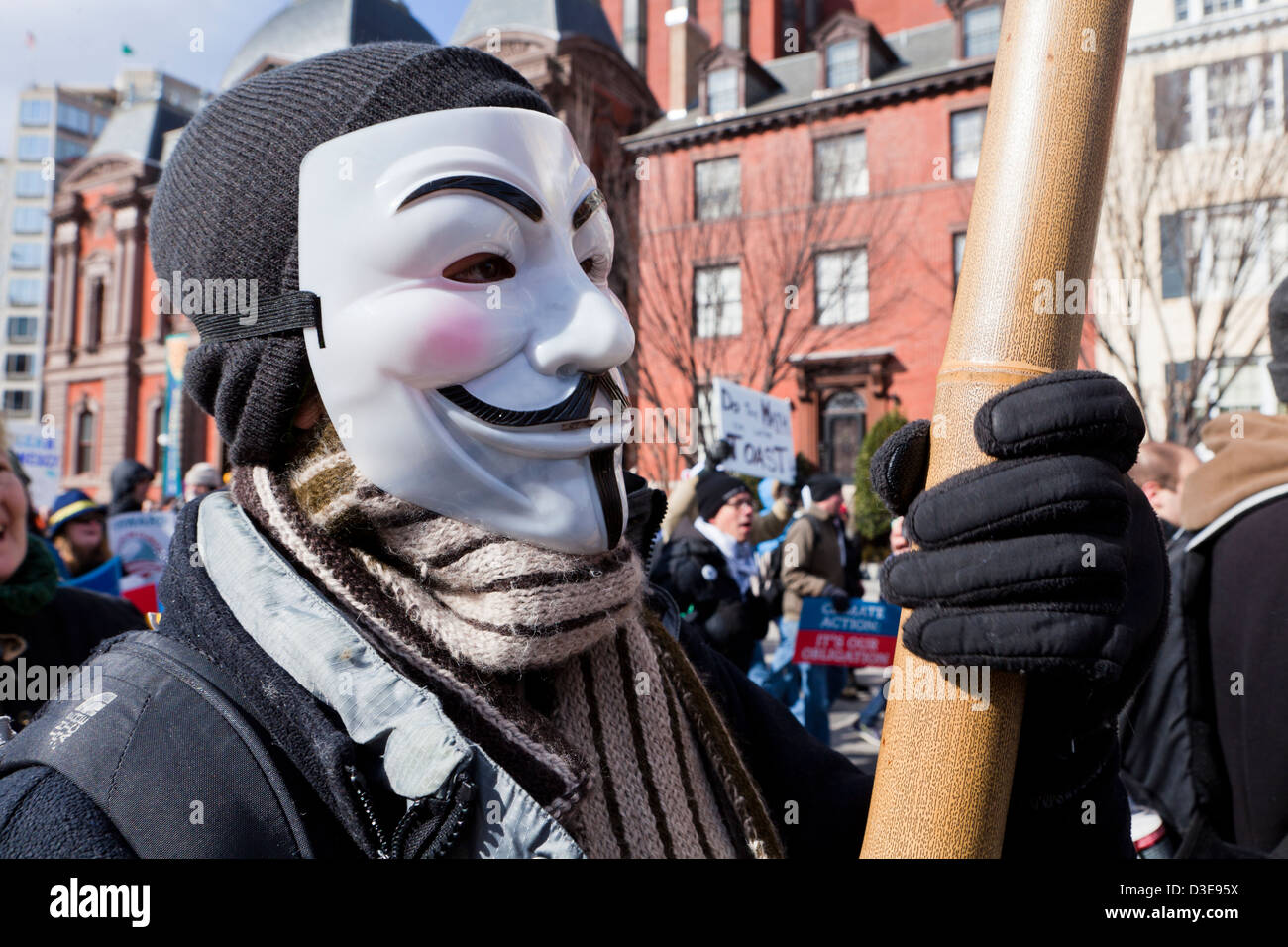 Man wearing a Guy Fawkes mask during protest rally Stock Photo