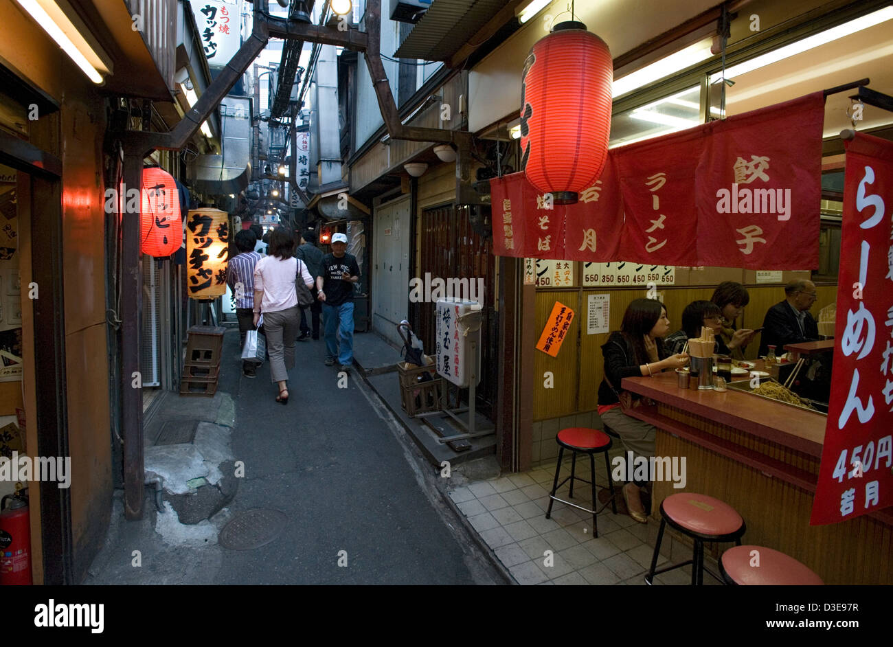 Unchanged since 1950's a narrow alley called Omoide Yokocho, or Memory Lane, in Shinjuku, Tokyo is packed with small restaurants Stock Photo