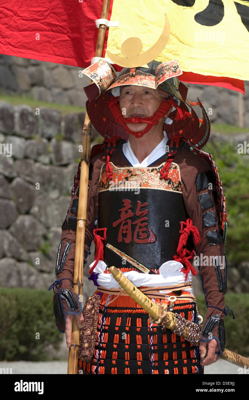 An elderly Sunday samurai warrior wearing a traditional armor costume poses for a photo at a festival at Odawara Castle. Stock Photo