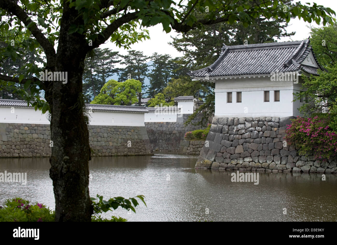 Water-filled moat with guard tower and stone fortress walls at Odawara Castle, former stronghold of Doi Clan in Kamakura Period Stock Photo