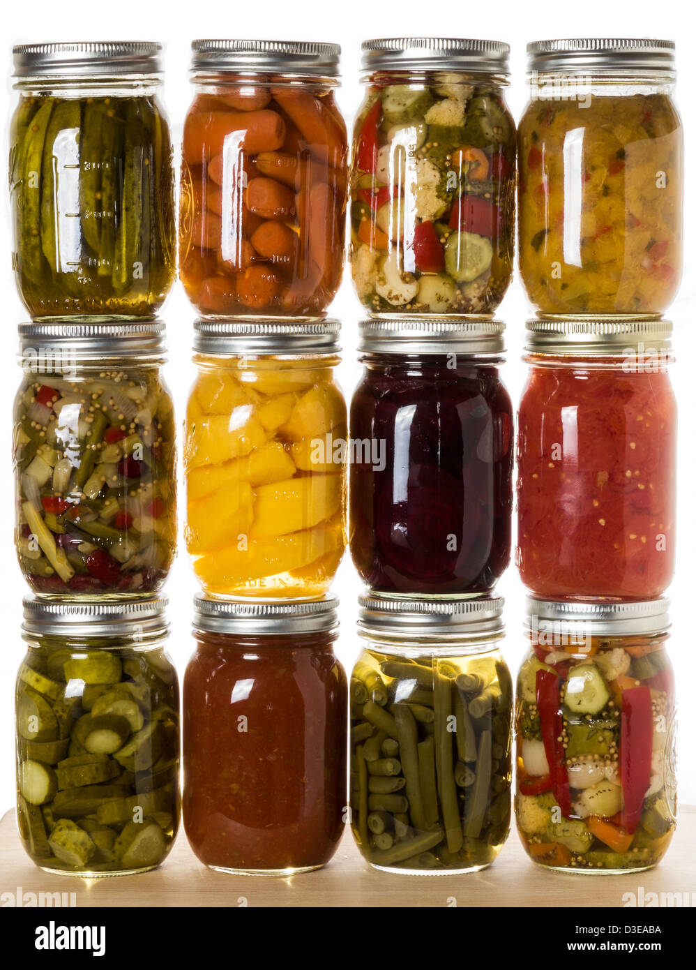 A stack of fresh fruits and vegetables canned up in jars Stock Photo