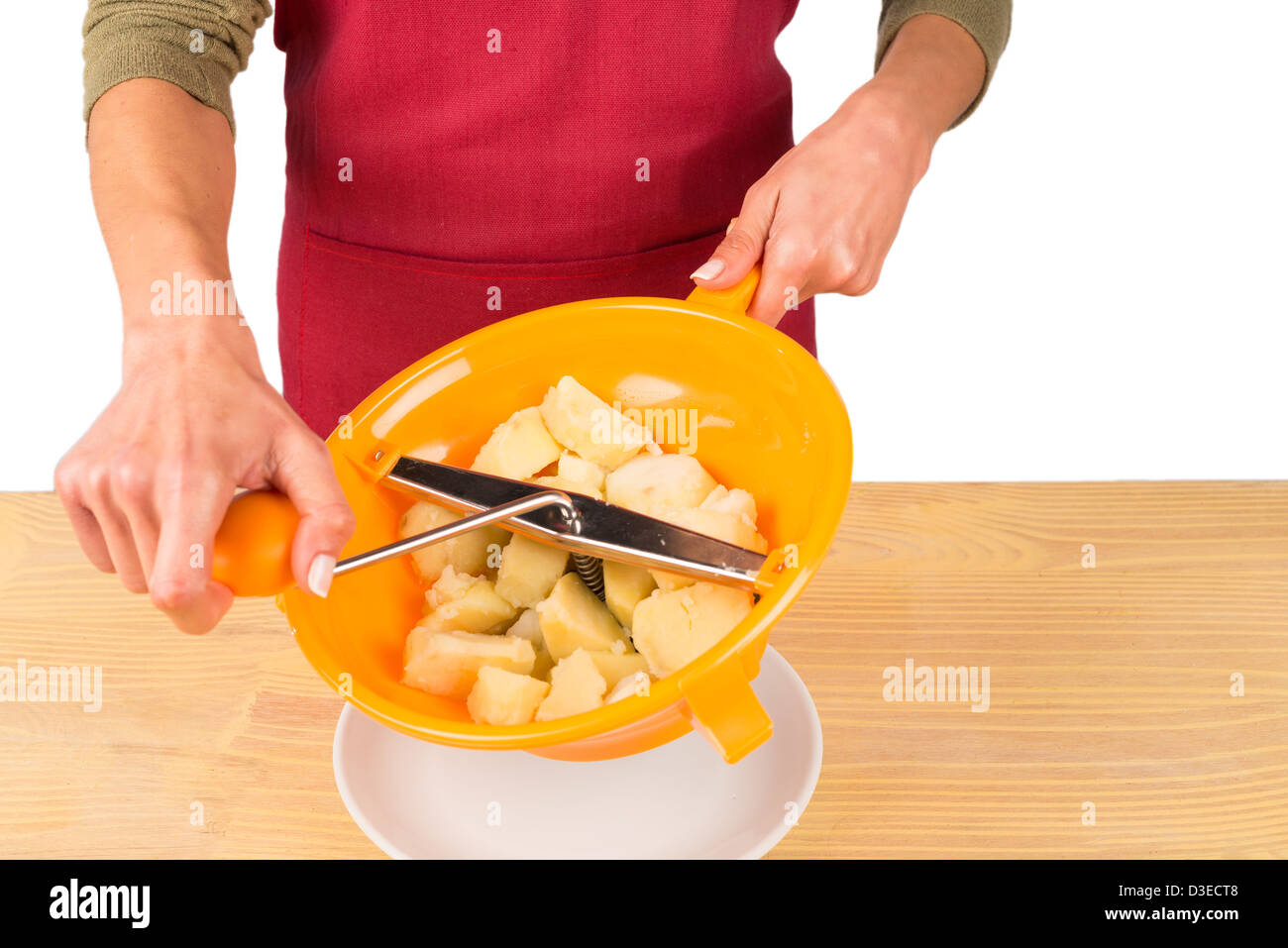 Mashing potatoes using a food mill Stock Photo Alamy