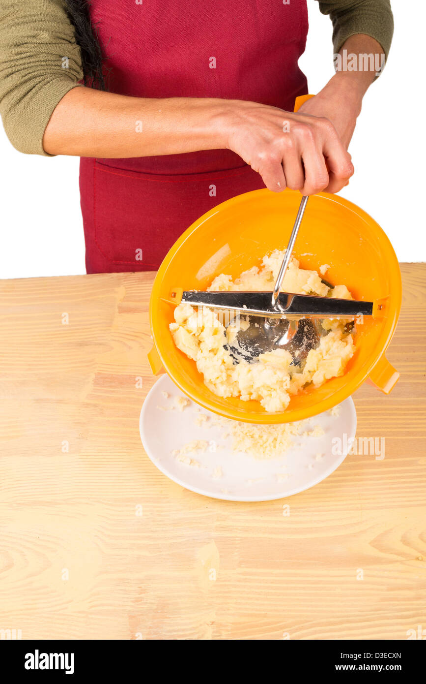 Rotating food mill while preparing mashed potatoes Stock Photo Alamy