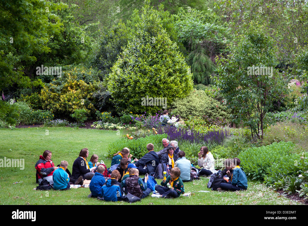 Scouts sitting on the lawn in St. James's Park, London, England, UK, Europe Stock Photo