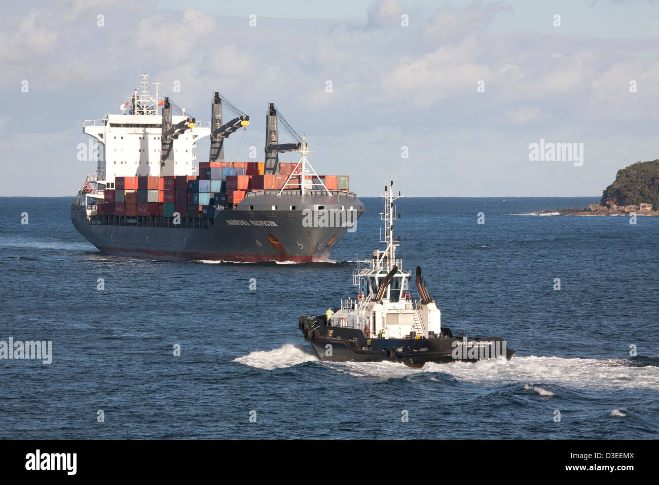 International container ship arriving at Port Botany container terminal with the assistance of