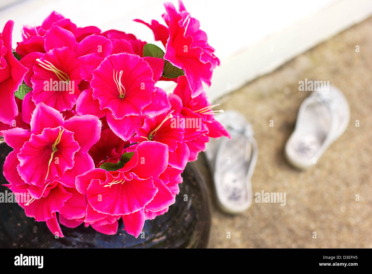 Pink artificial flowers near entrance Stock Photo Alamy