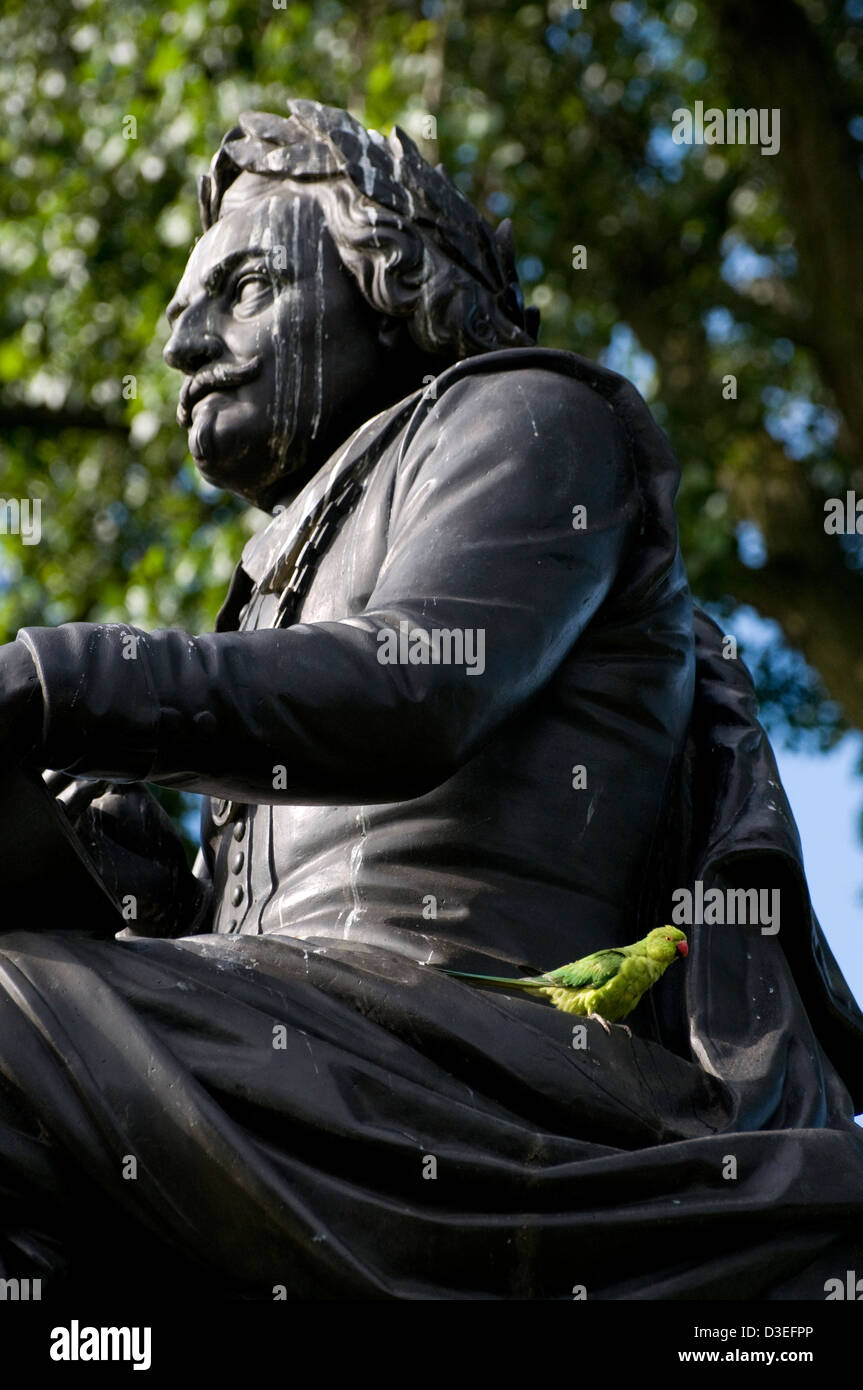 rose-ringed parakeet,psittacula krameri,drinking from statue of joost van den vondel,vondelpark,amsterdam,netherlands Stock Photo