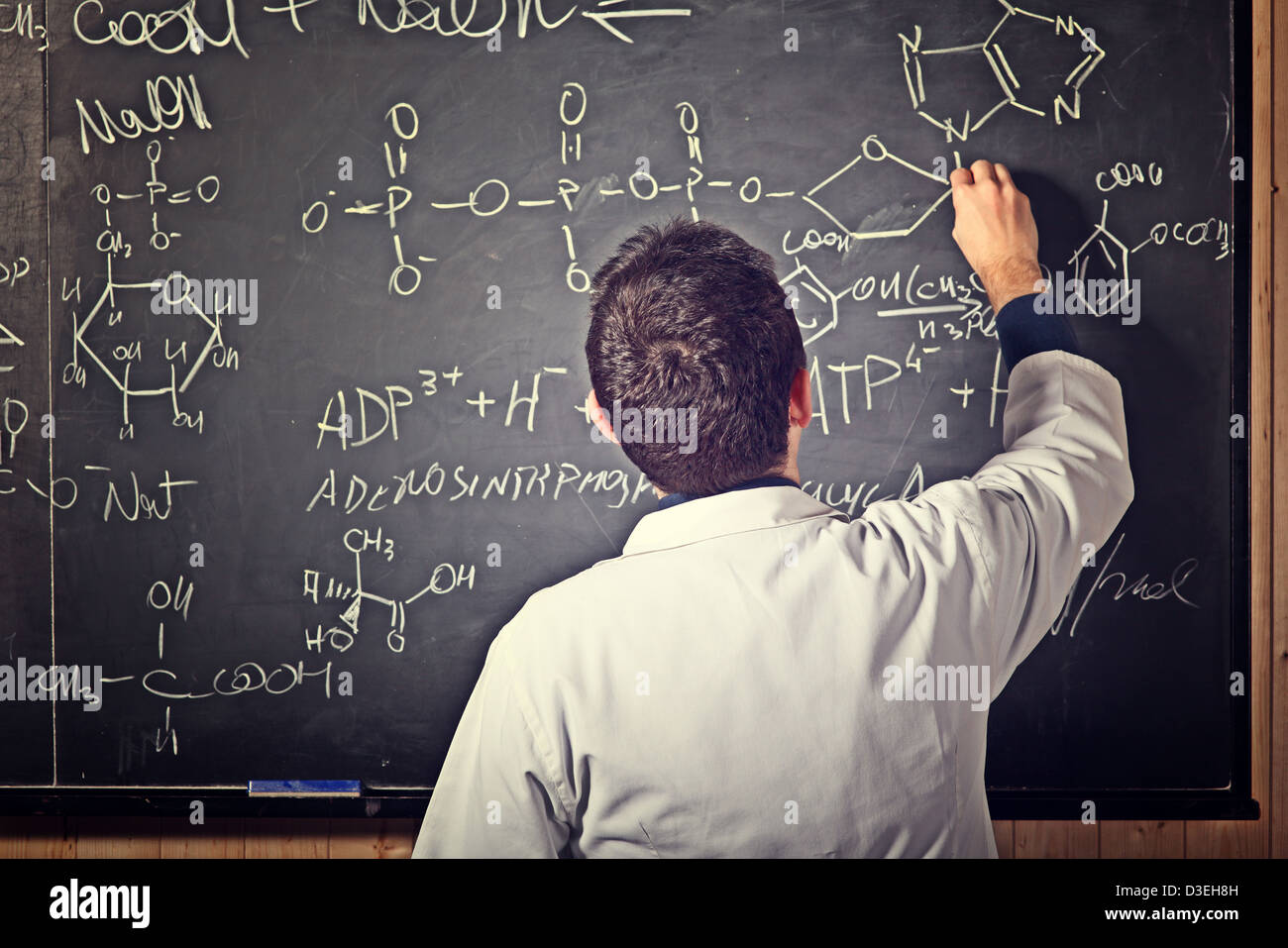 portrait of teacher with blackboard background Stock Photo