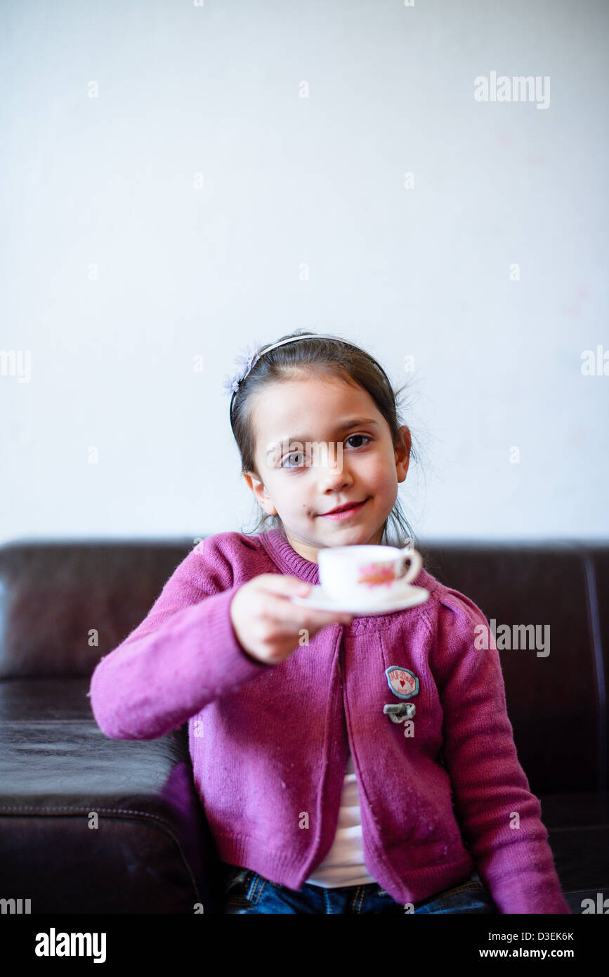 child is drinking from the cup Stock Photo Alamy