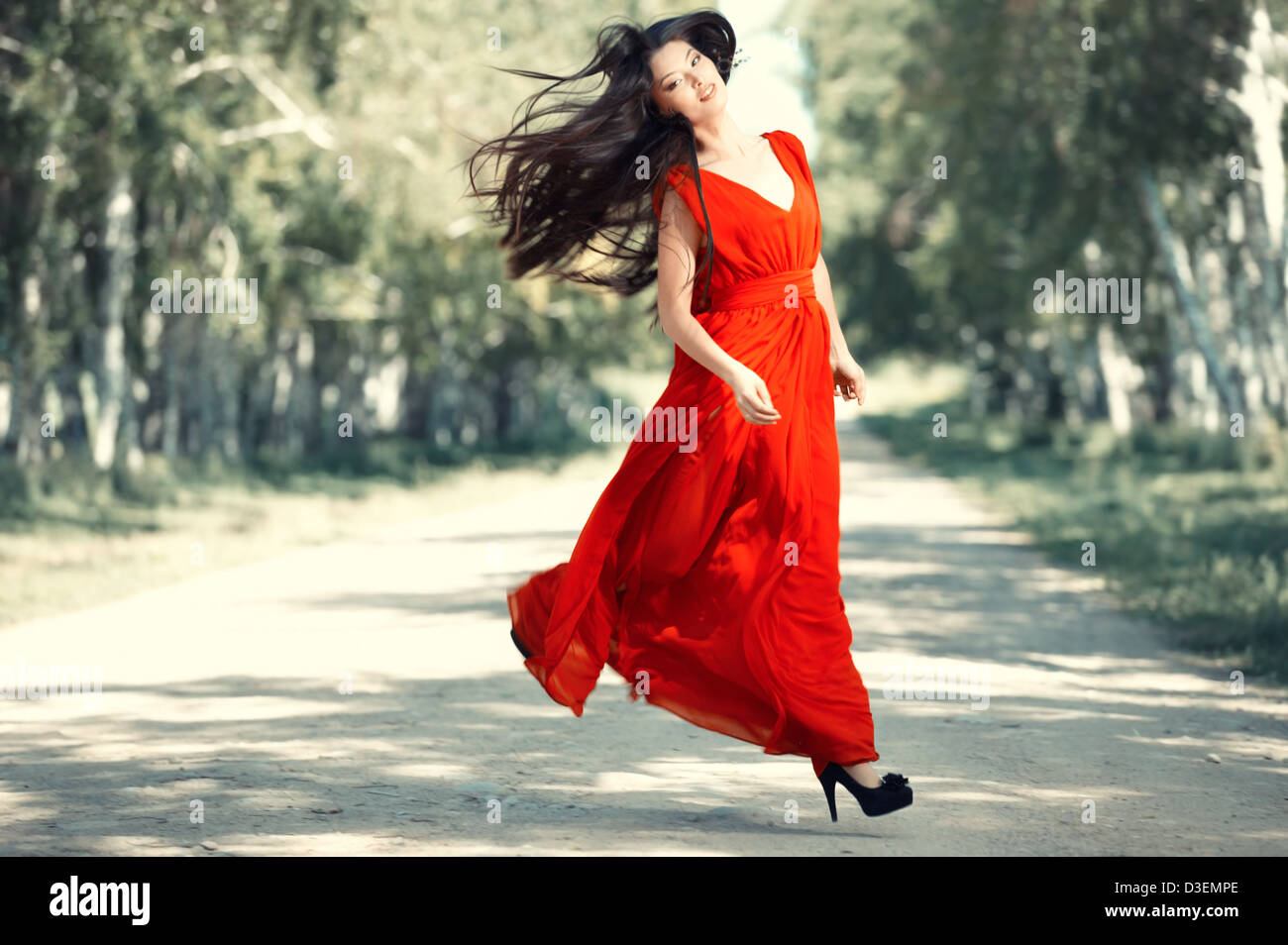 Asian lady in red dress running outdoors Stock Photo Alamy