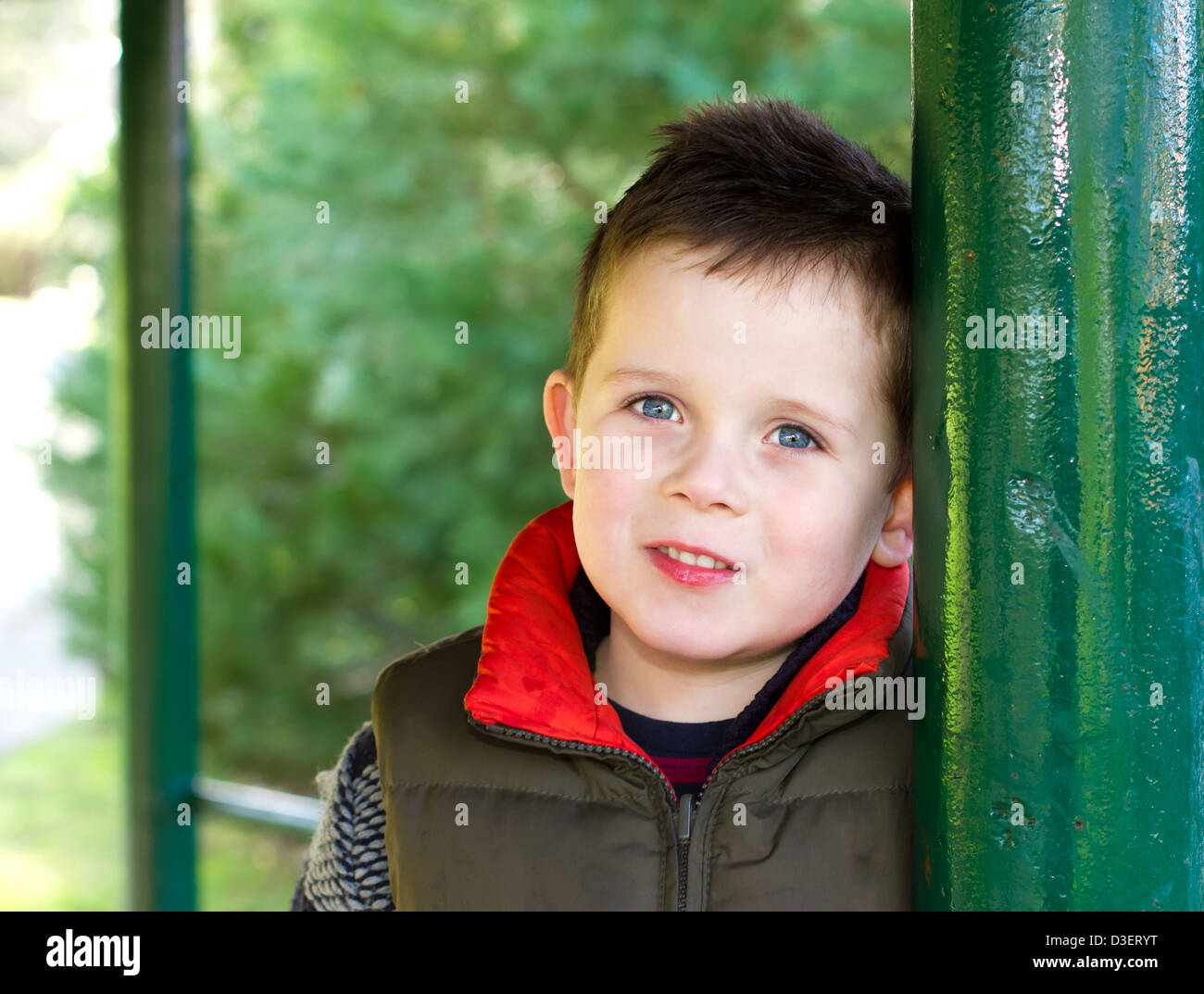 Happy young boy smiling in an outdoor scene Stock Photo