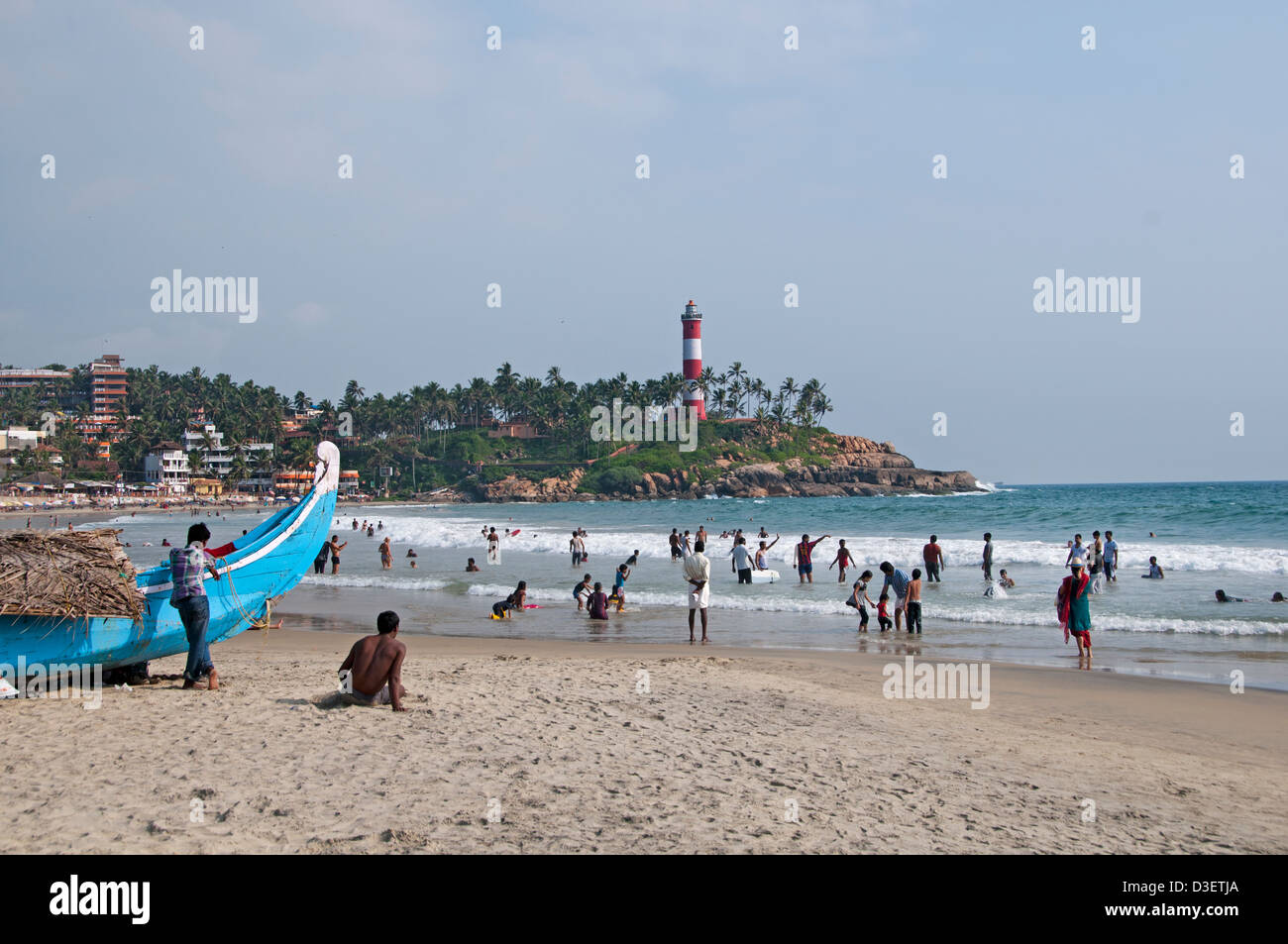 Kovalam Beach Kerala India Indian sea people water lighthouse pharos Stock Photo