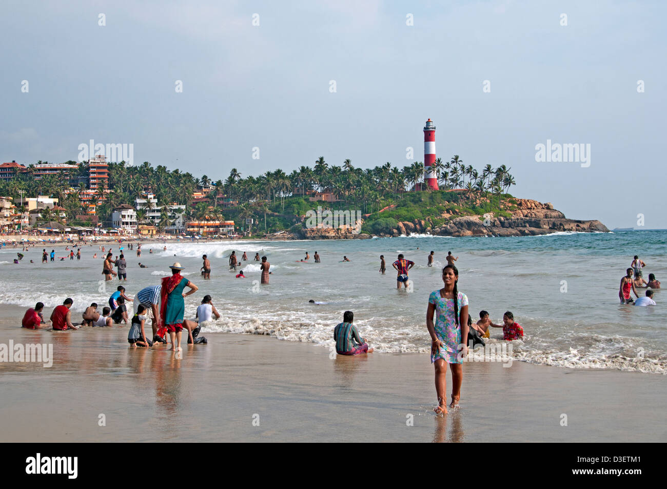 Kovalam Beach Kerala India Indian sea people water lighthouse pharos Stock Photo