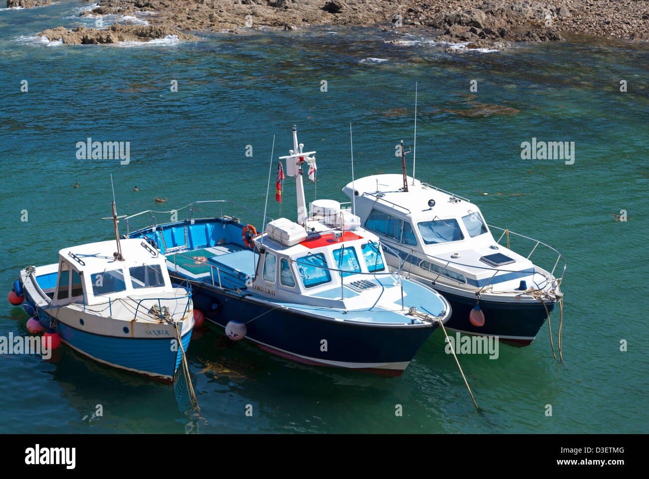 Three small fishing boats in the harbour at Bonne Nuit bay, Jersey