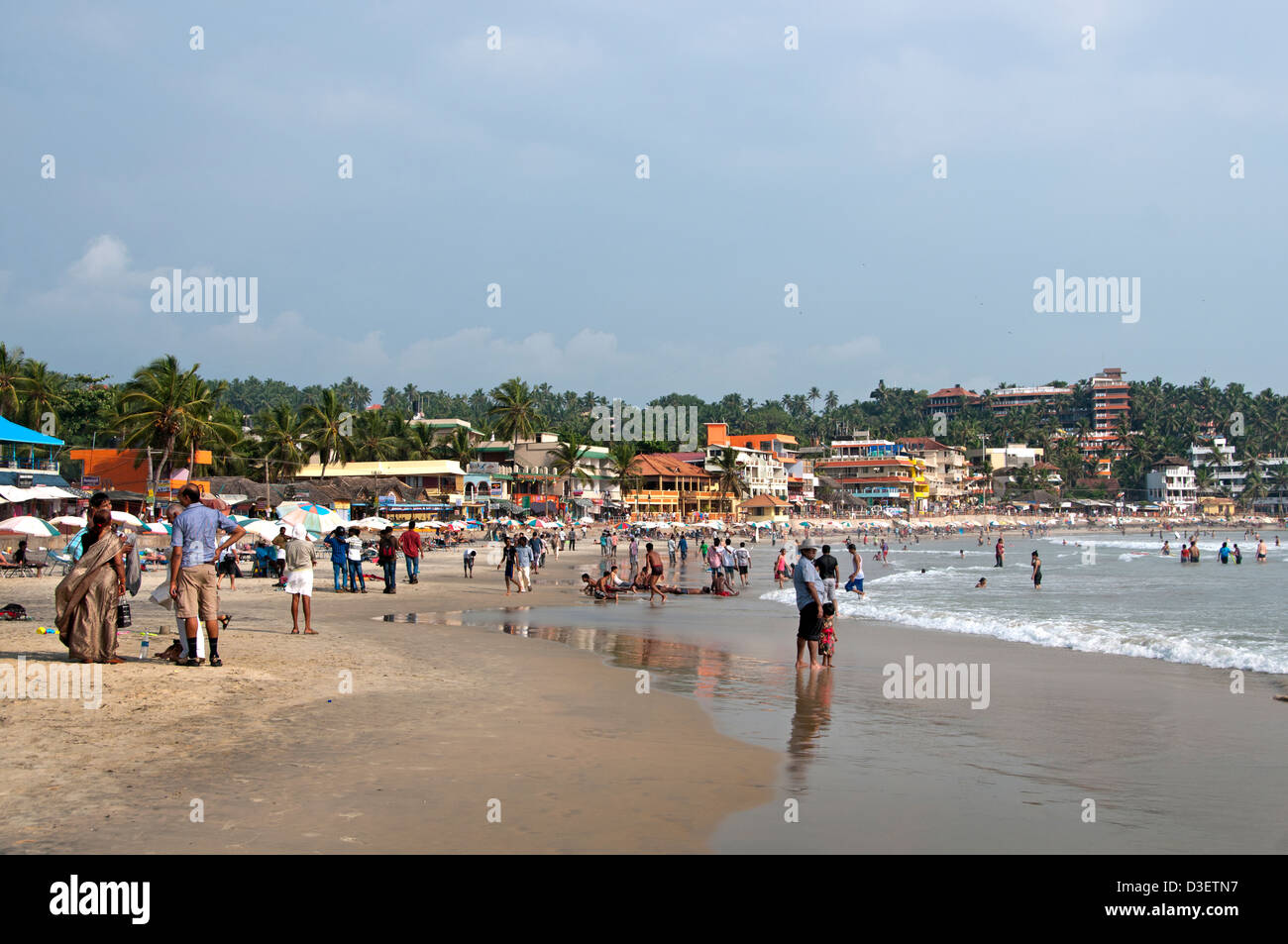 Kovalam Beach Kerala India Indian sea people water lighthouse pharos Stock Photo