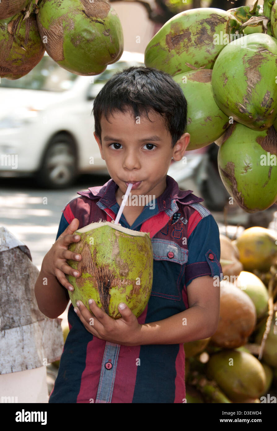 Kochi Cochin Kerala India Little Boy coconut drink Stock Photo