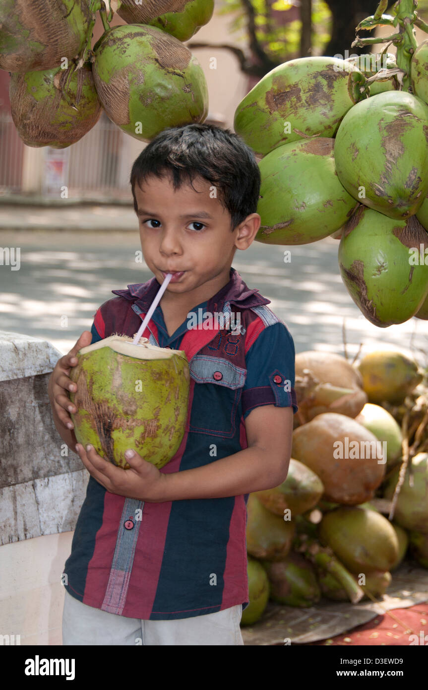 Kochi Cochin Kerala India Little Boy coconut drink Stock Photo