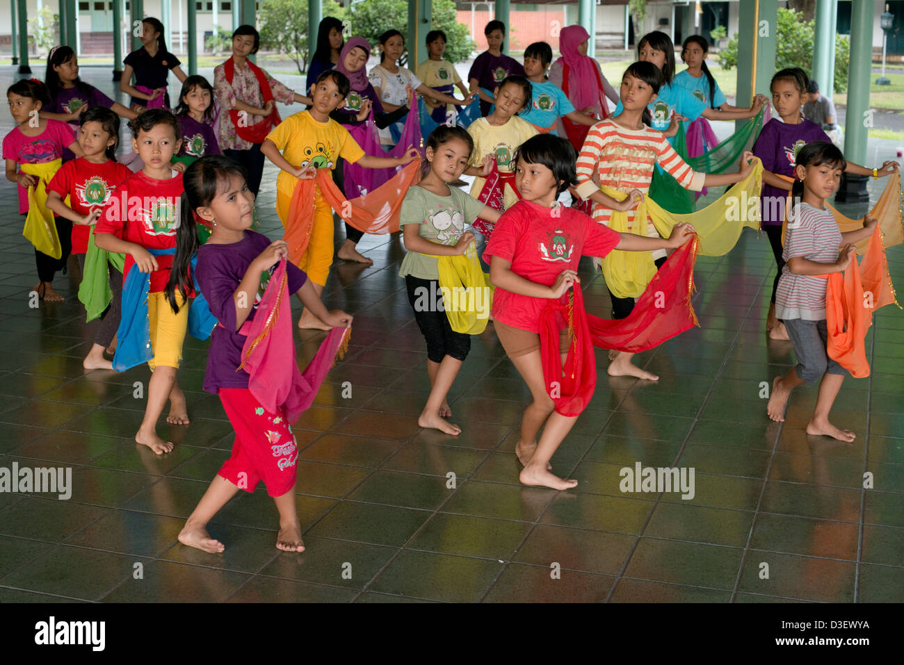 A group of young Javanese dance students practice traditional dance movements in Solo (Surakarta), Java, Indonesia Stock Photo