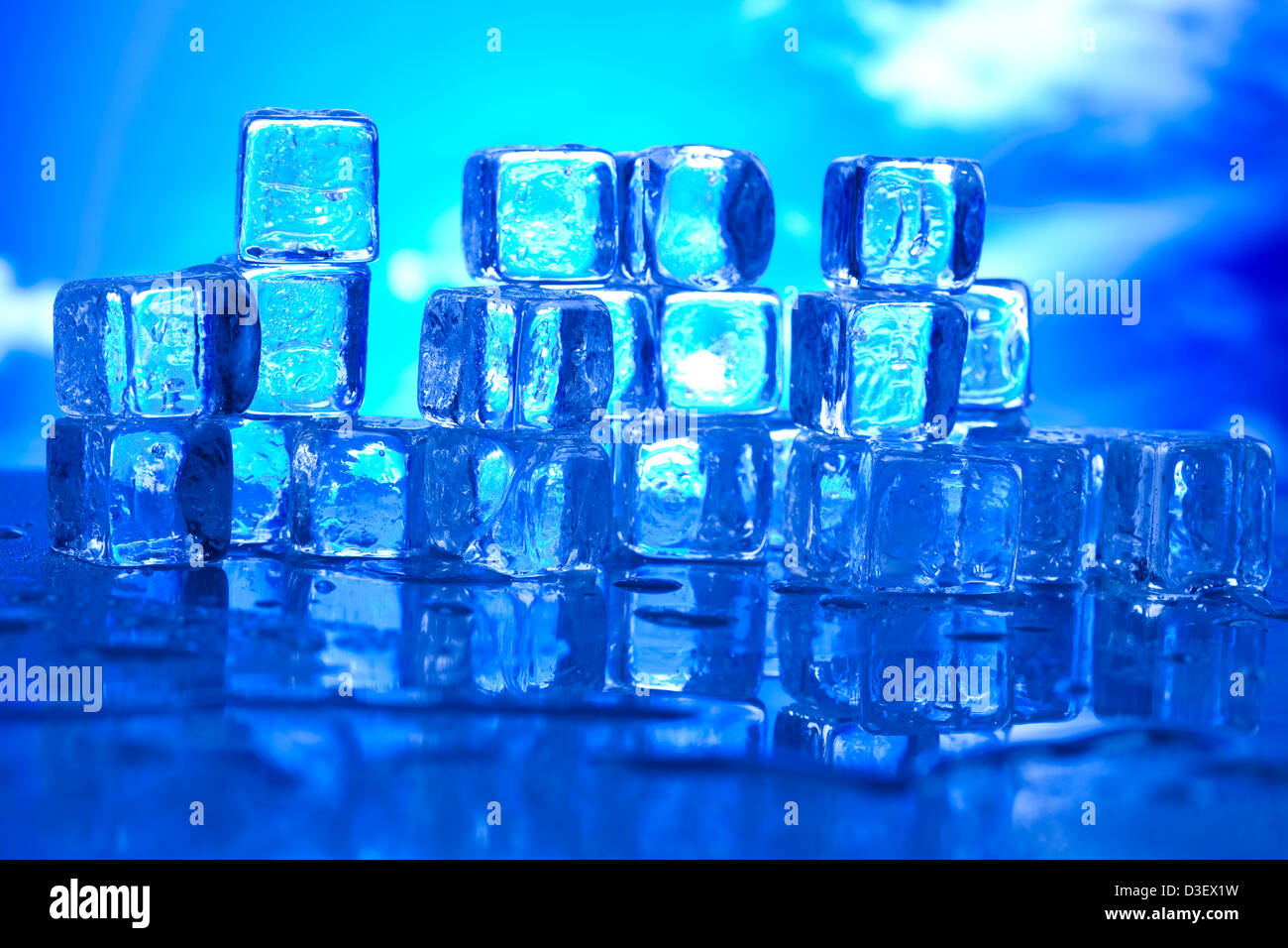 Transparent ice cubes and blue sky background Stock Photo - Alamy