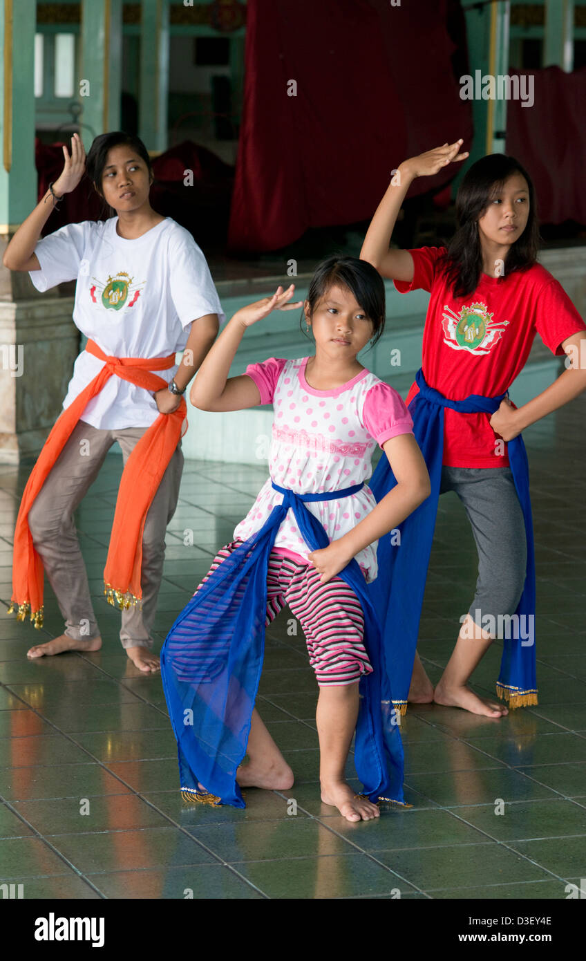 Three young Javanese dance students practice traditional dance movements in Solo (Surakarta), Java, Indonesia Stock Photo