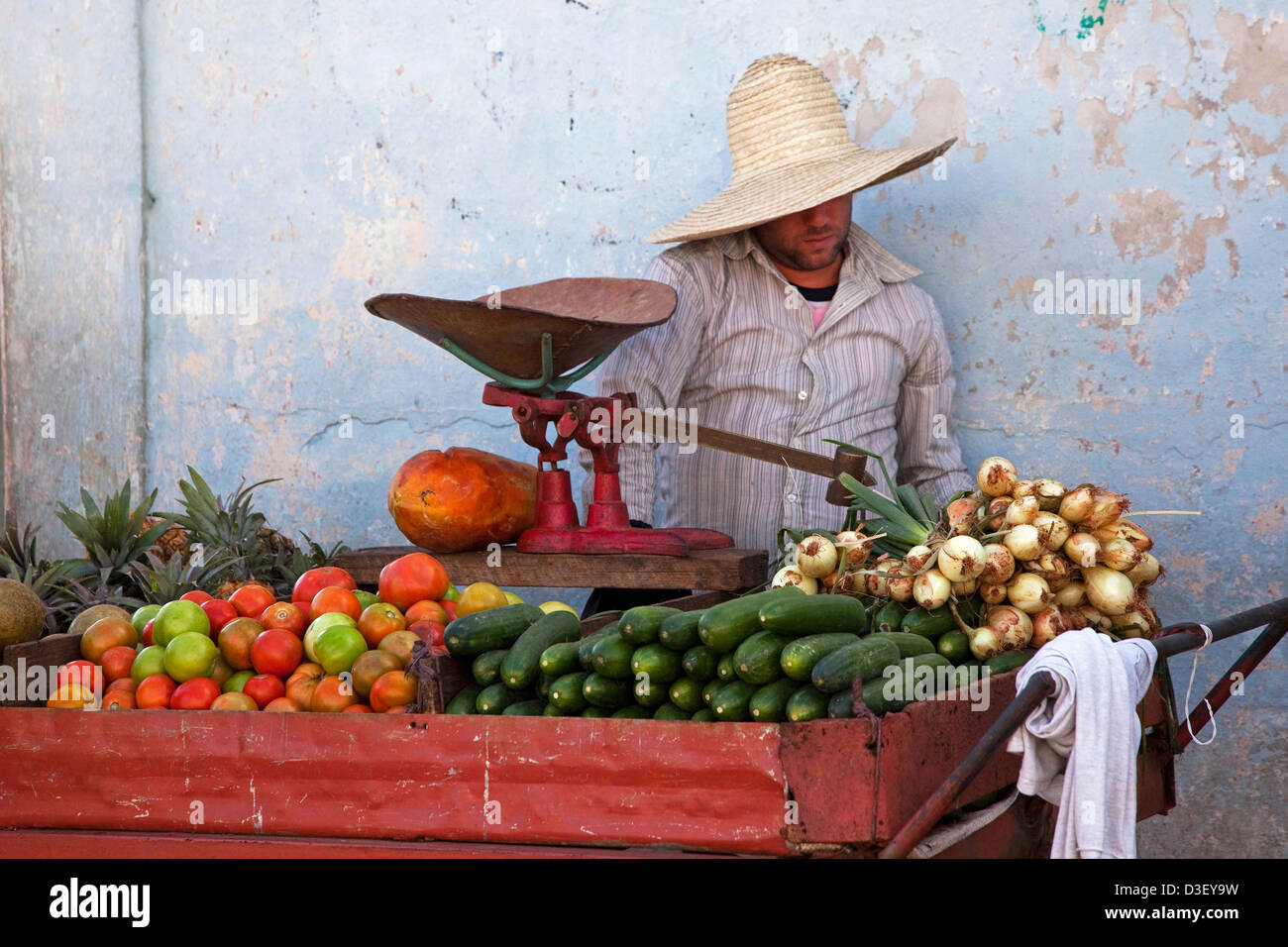 Cuban vendor selling fresh fruit and vegetables at market stall in Viñales, Cuba, Caribbean Stock Photo