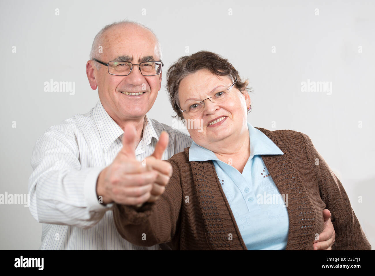 mature happy couple showing thumbs up Stock Photo