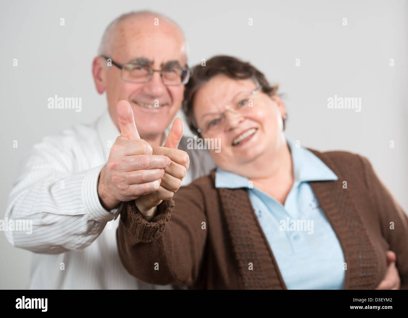 mature happy couple showing thumbs up Stock Photo