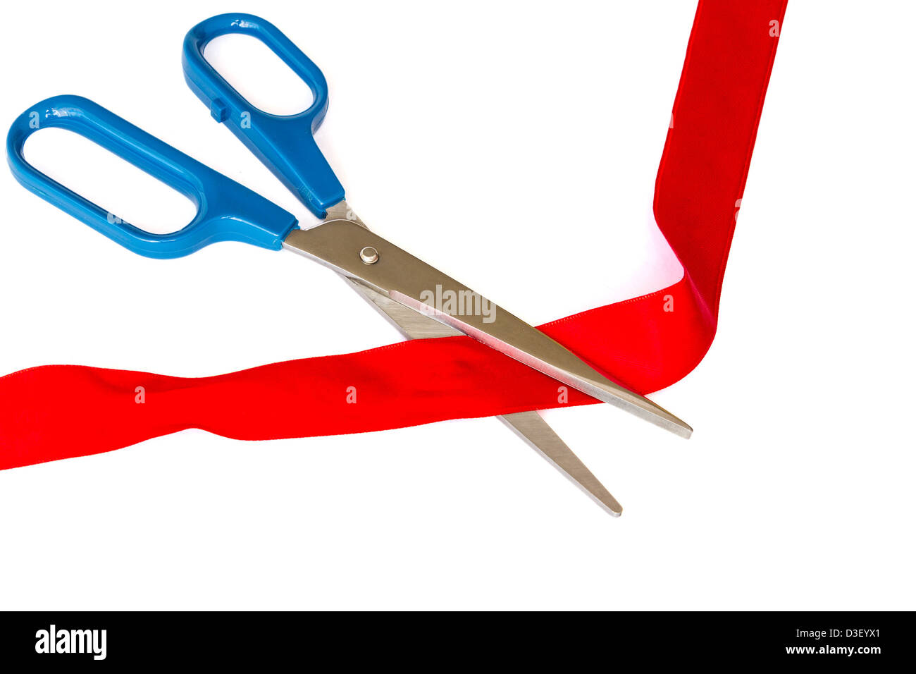 Closeup image of scissors cutting a red ribbon Stock Photo