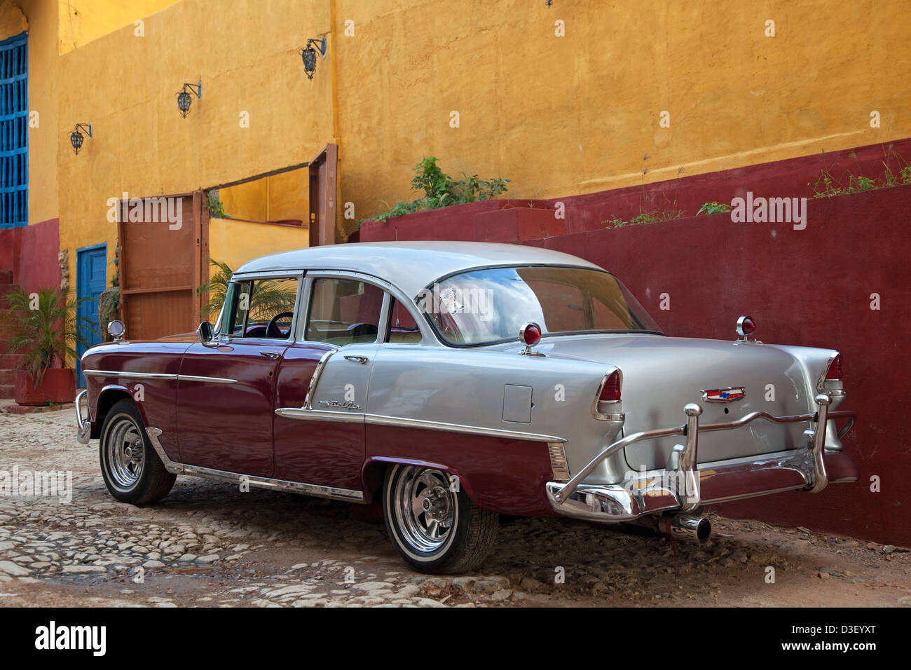 Pastel coloured house and old 1950s vintage American Chevrolet Bel Air car / Yank tank in Trinidad, Cuba, Caribbean Stock Photo