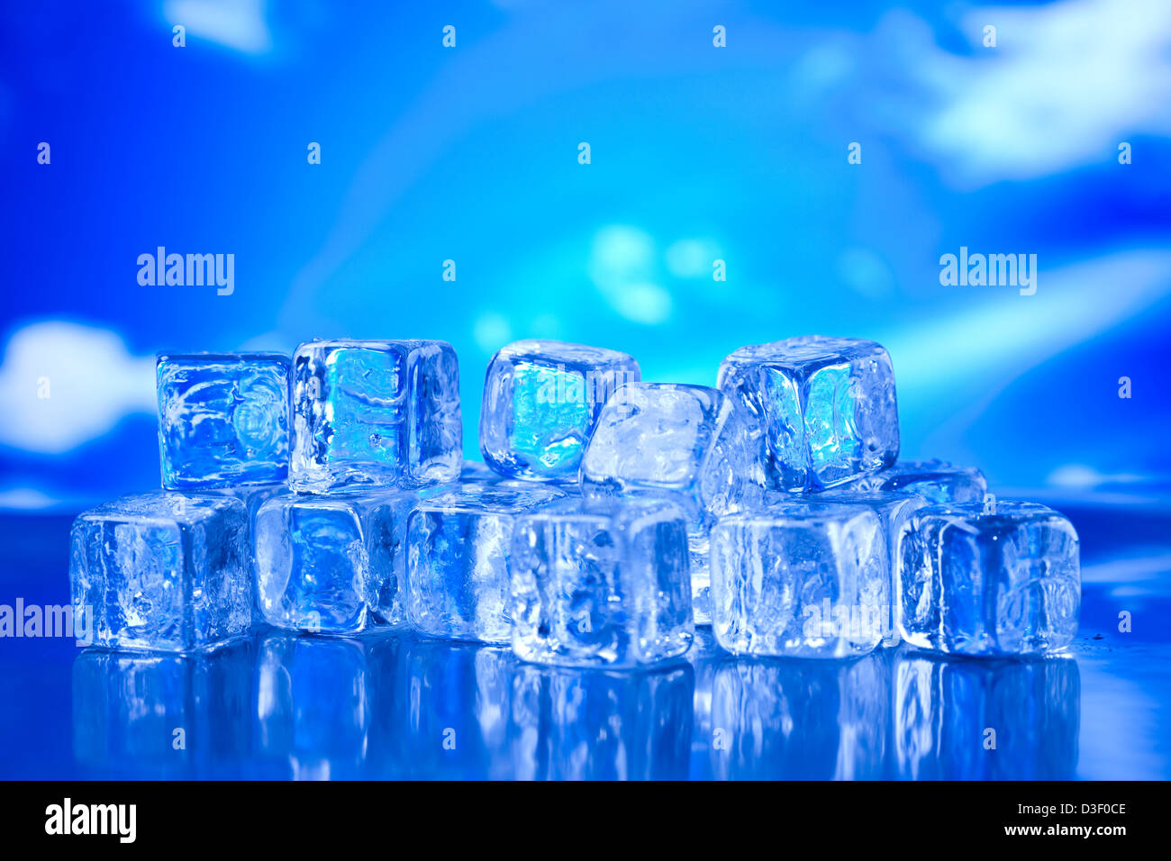 Transparent ice cubes and blue sky background Stock Photo - Alamy