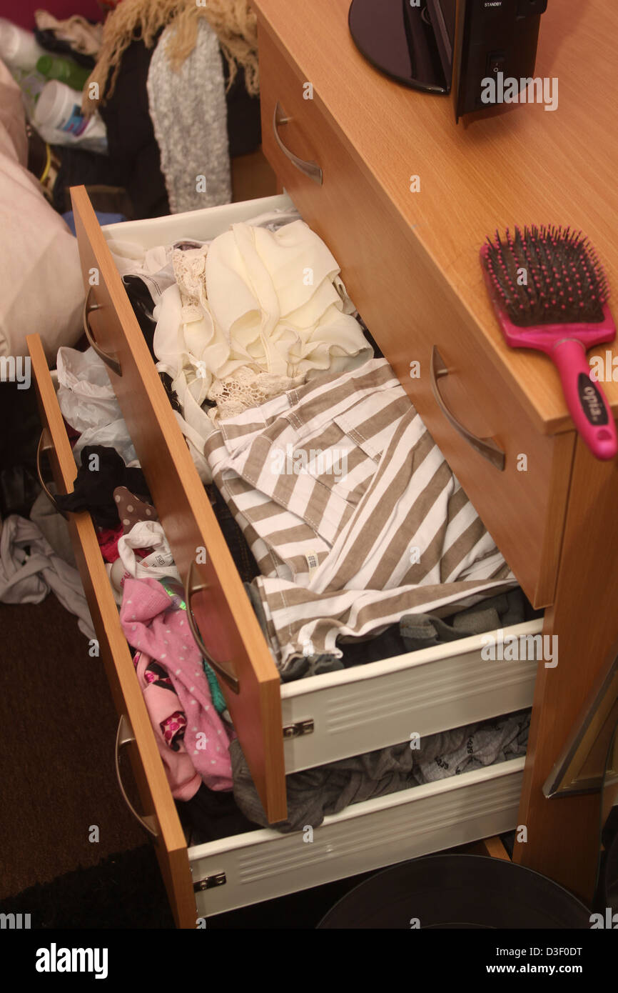 Drawers stuffed with girls clothes Stock Photo