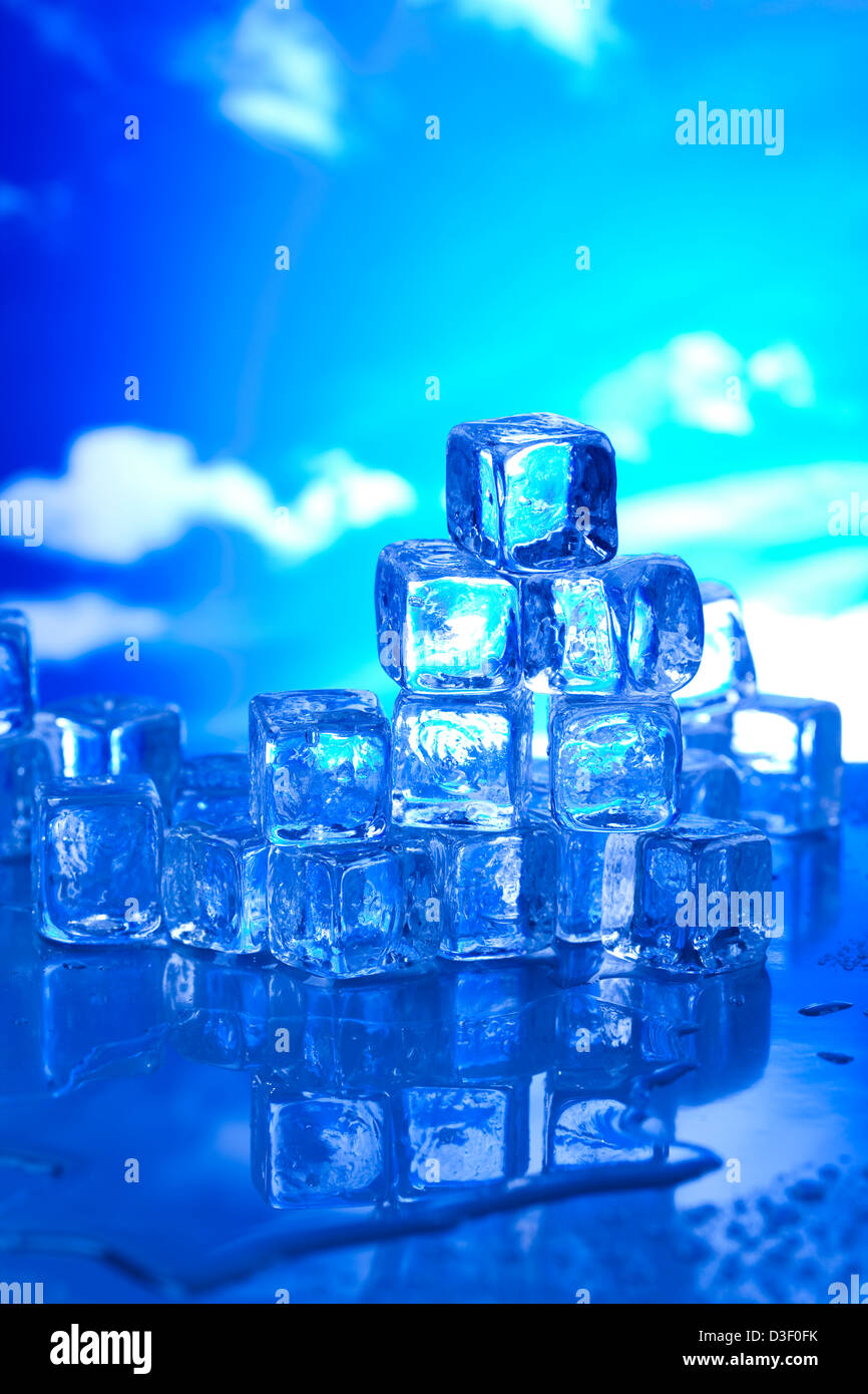 Transparent ice cubes and blue sky background Stock Photo - Alamy